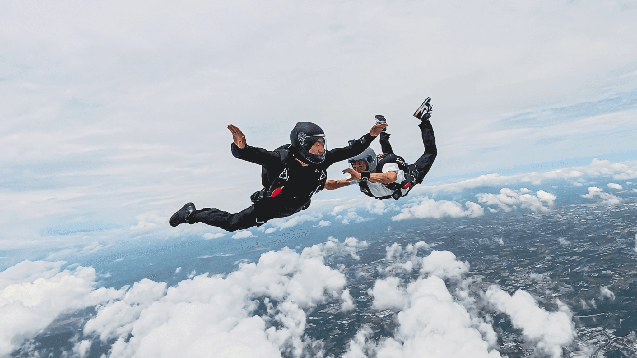 Licensed skydivers flying together in formation