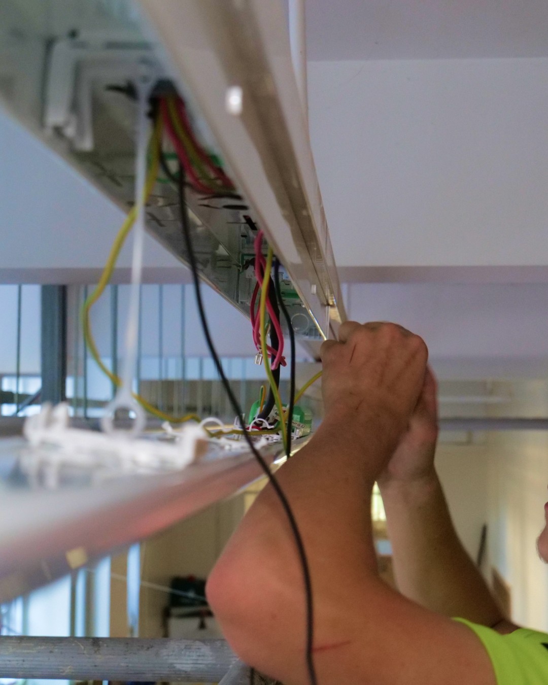 Azure Electrical Ltd Apprentice chaning the lights in a school in London