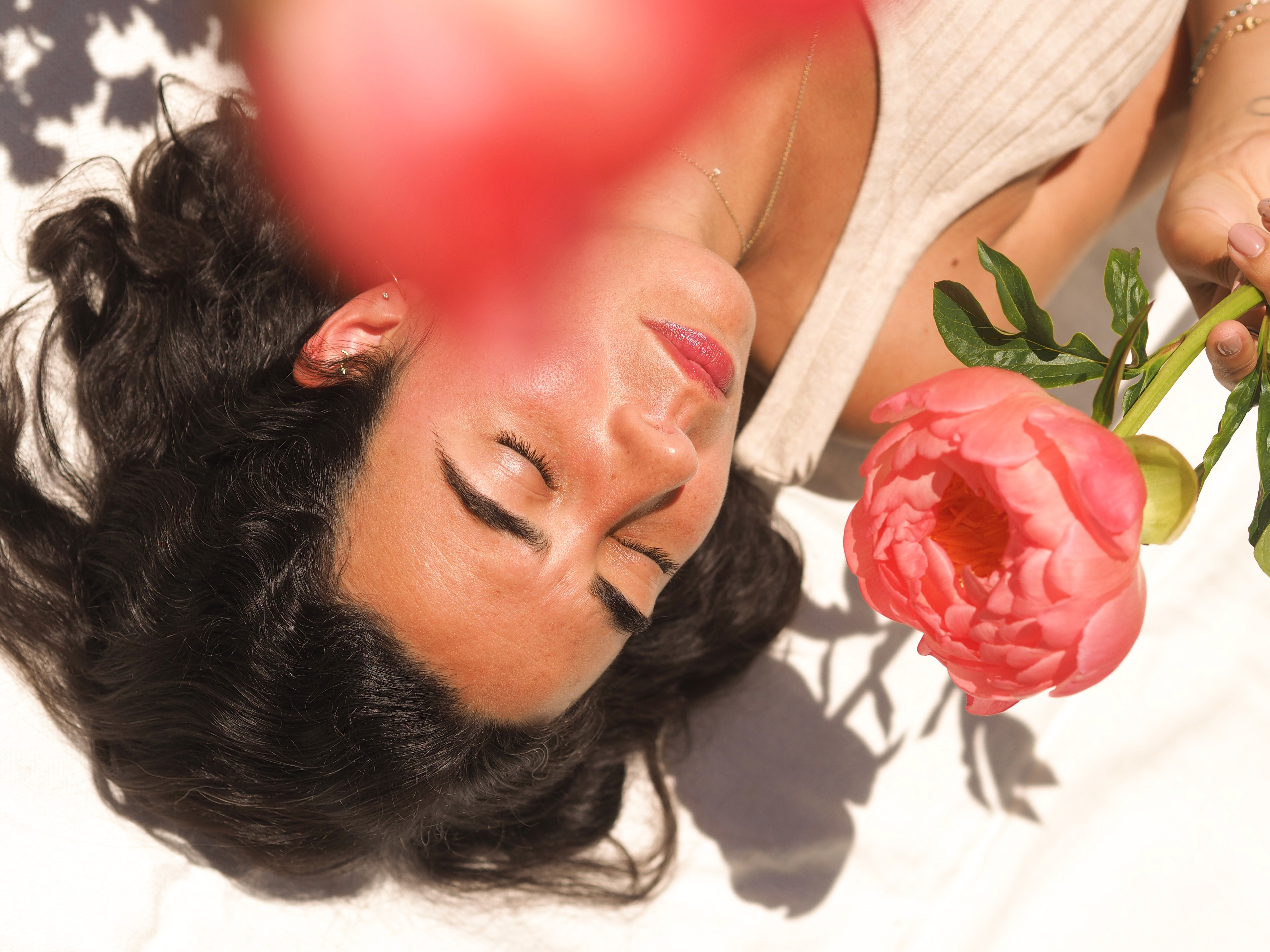 a woman holding a red flower