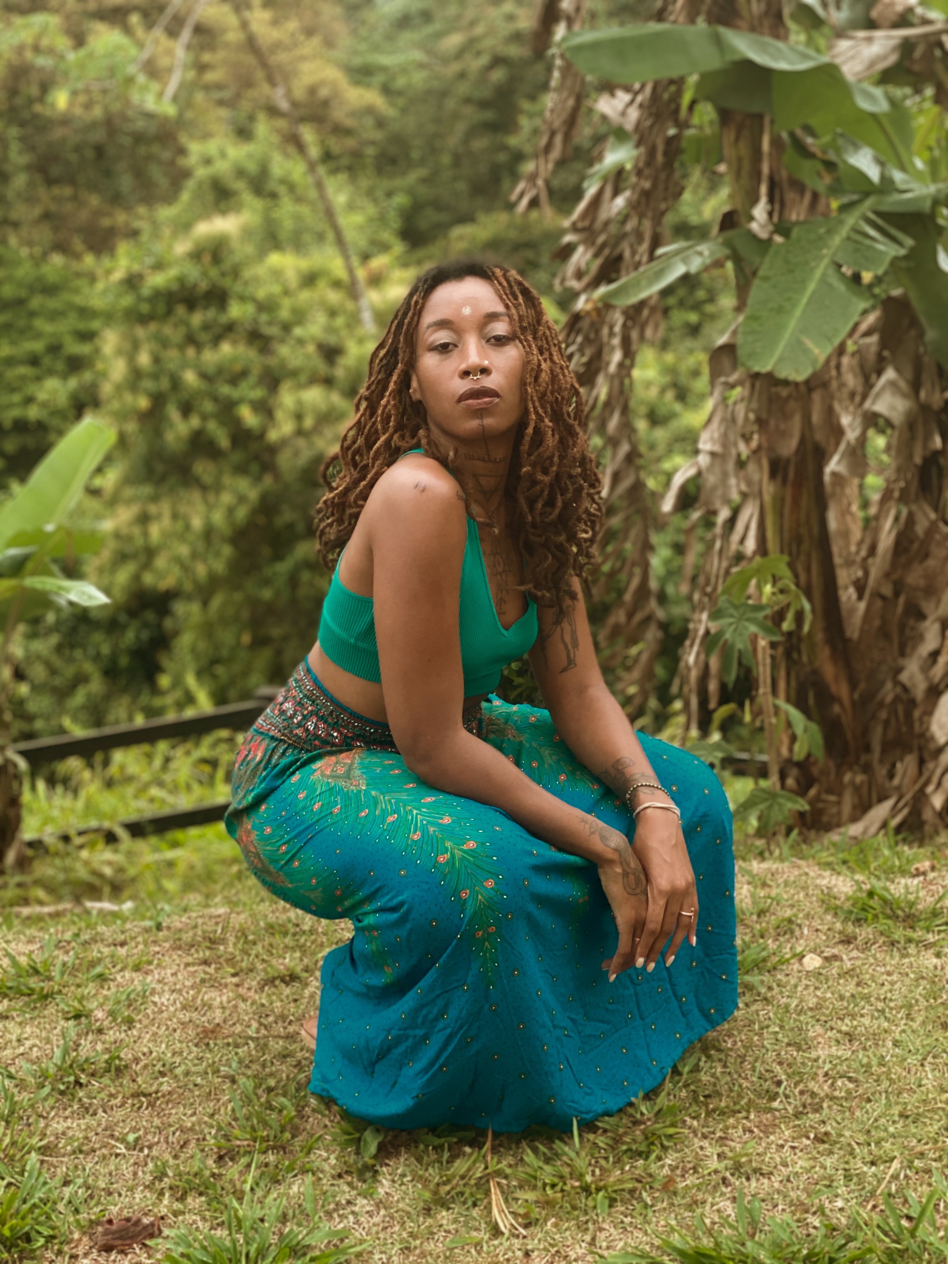Man in apron stands in rustic kitchen, hands dusted with flour.