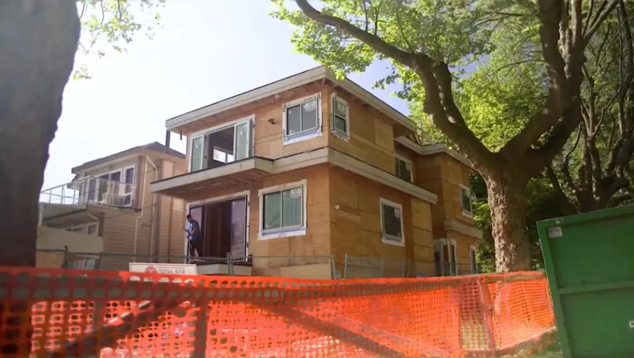 Multiplex home under construction with exterior framing and windows installed