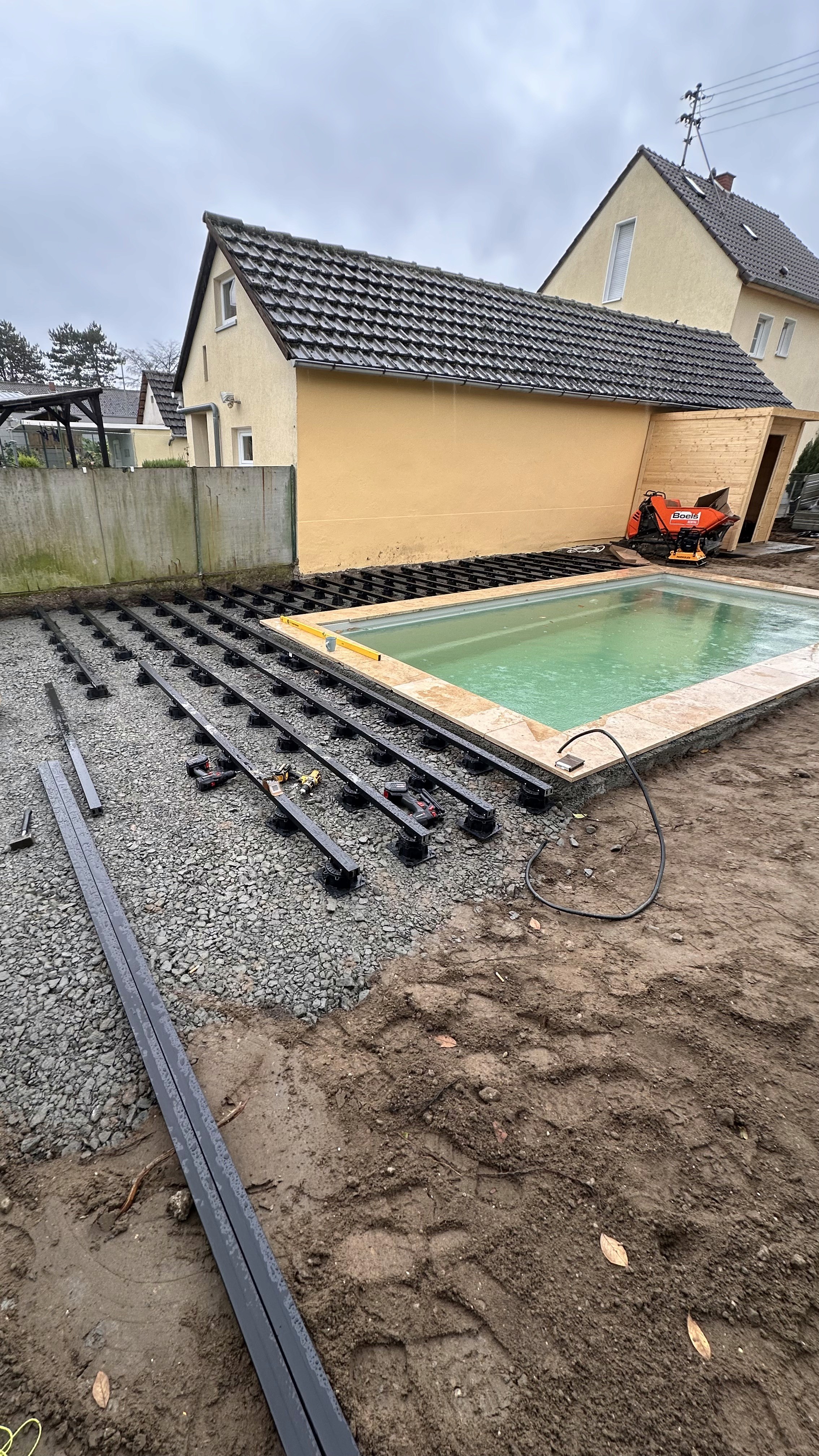 A man stading with Surfboard
