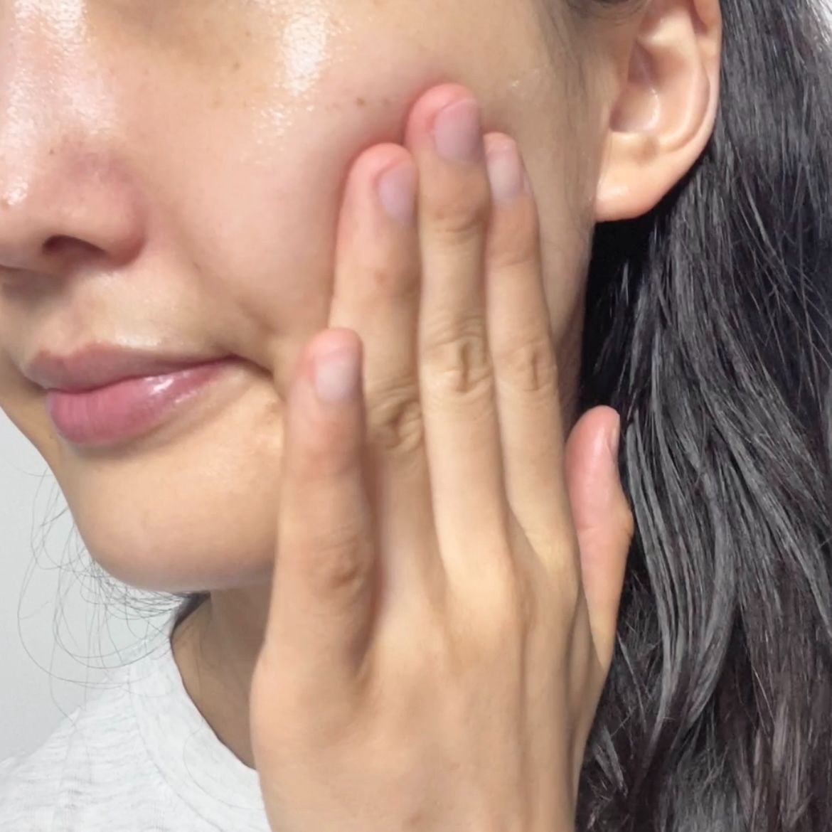 smiling woman wearing white and black pinstriped collared top