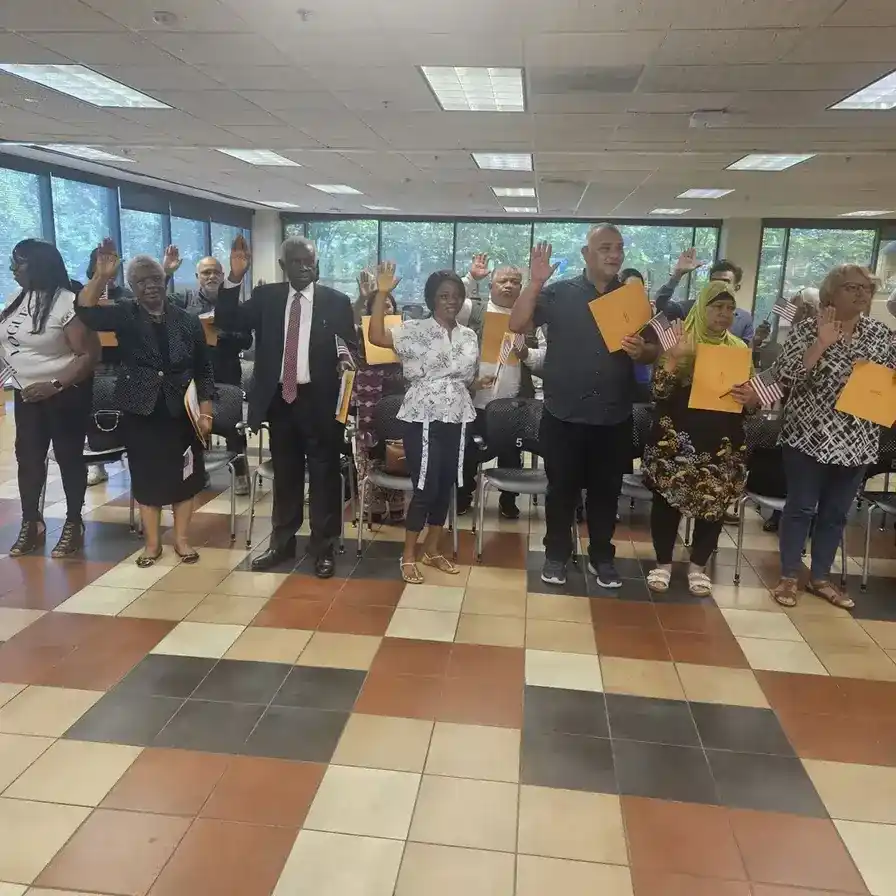 Ecstatic individual holding U.S. flag after naturalization, aided by Fibi Law