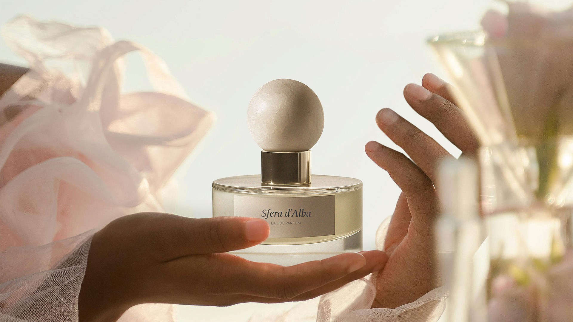 View of the French countryside through a stone villa’s open living room, with sofas and trees framing the scene