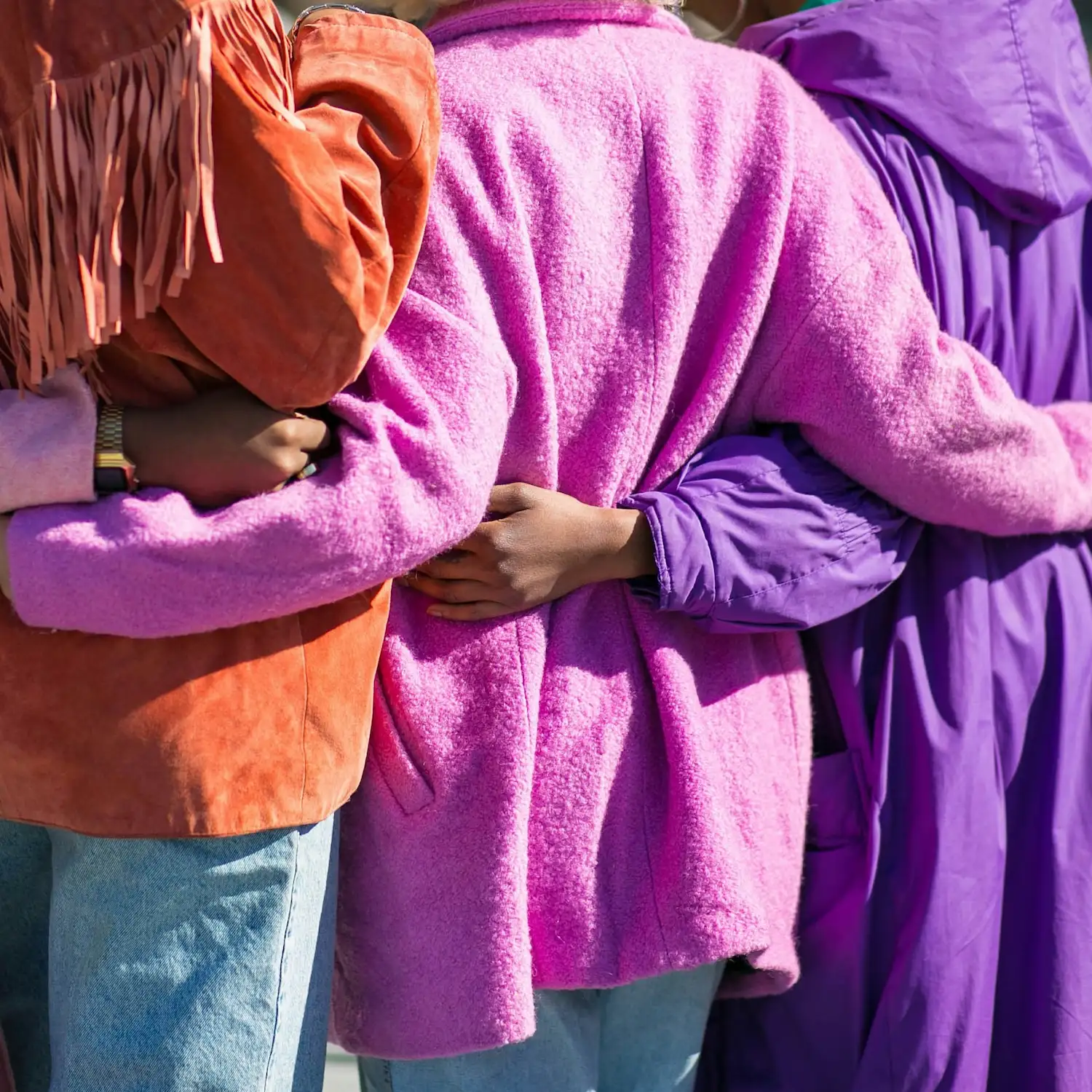 Close-up of diverse group of people standing together with arms around each other, symbolizing connection, support, and inclusivity during group therapy sessions in NYC.