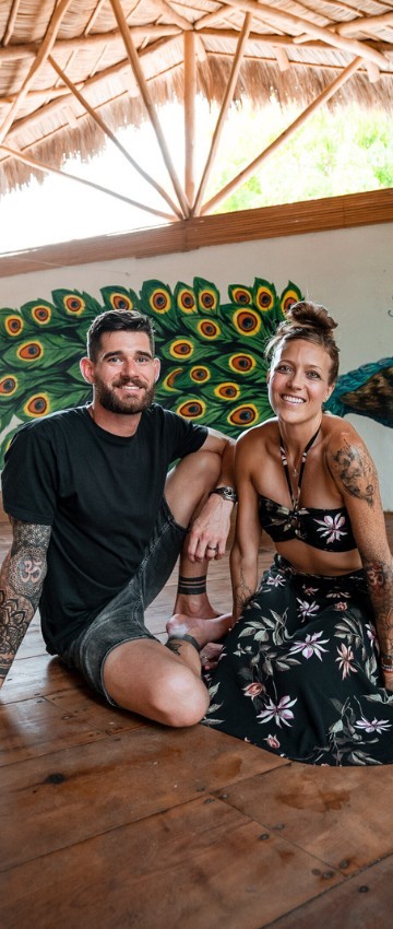 Flo practicing a standing yoga balance pose on a mat in a home setting.