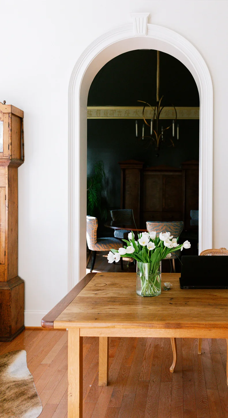 A light-filled Manhattan townhouse with an arched doorway, original wood floors and crown moulding