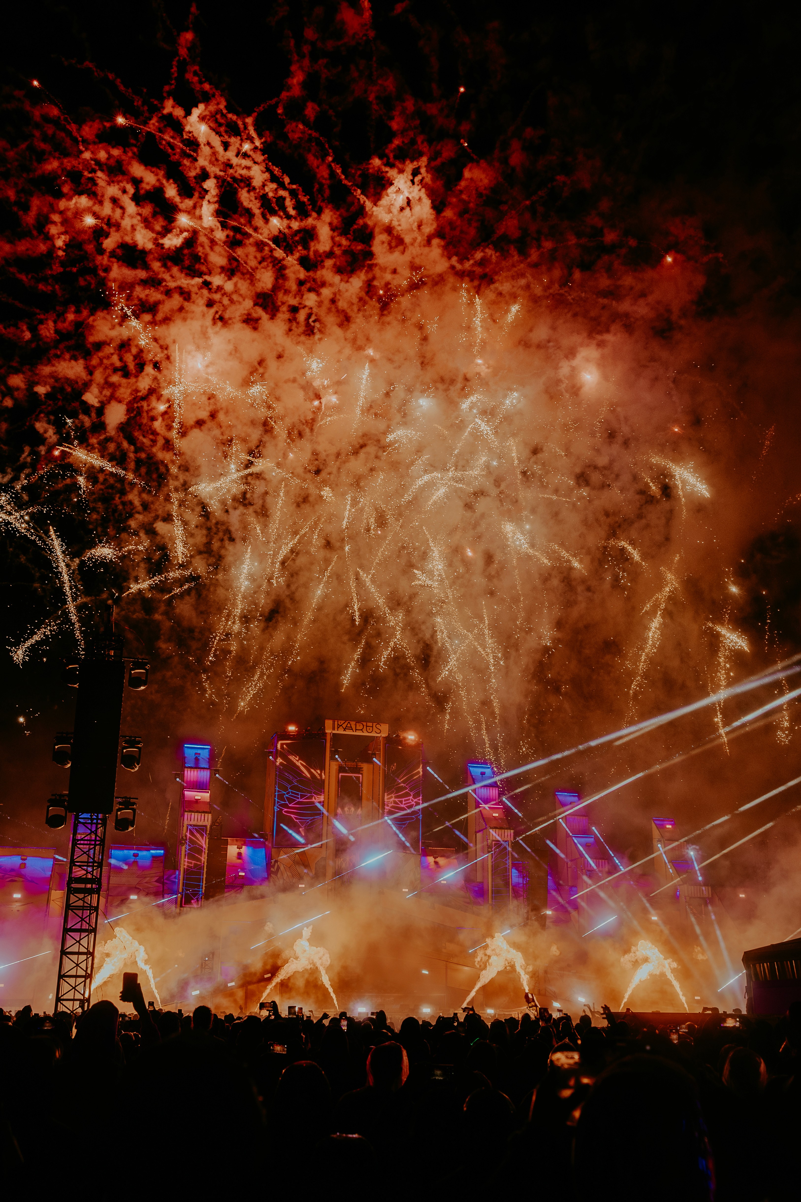 People playing soccer on a rooftop court surrounded by city buildings