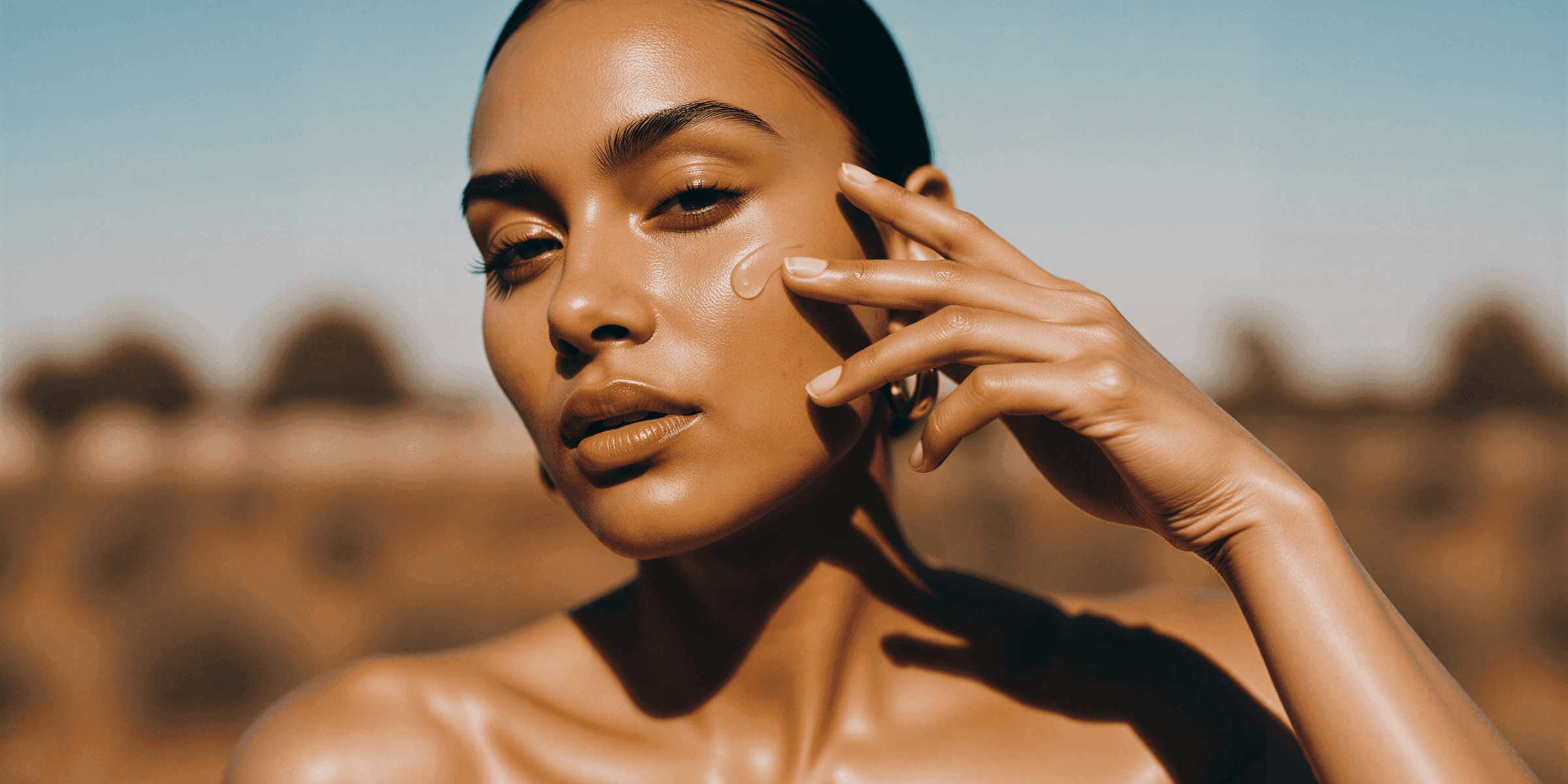a woman applying a product to her face, highlighting her radiant skin.