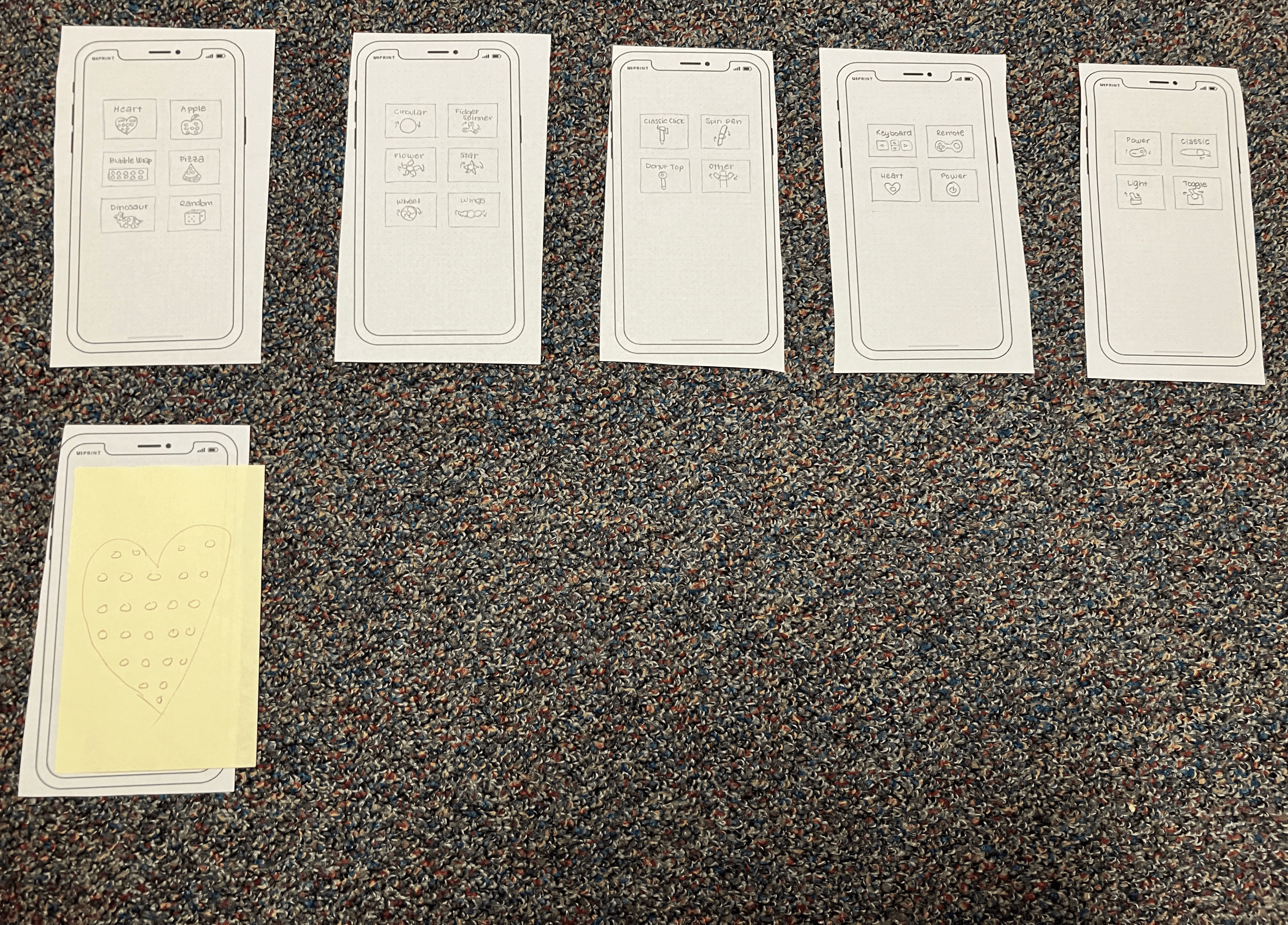 Paper screens of Fidgy, with a post-it to simulate the selected fidget choice