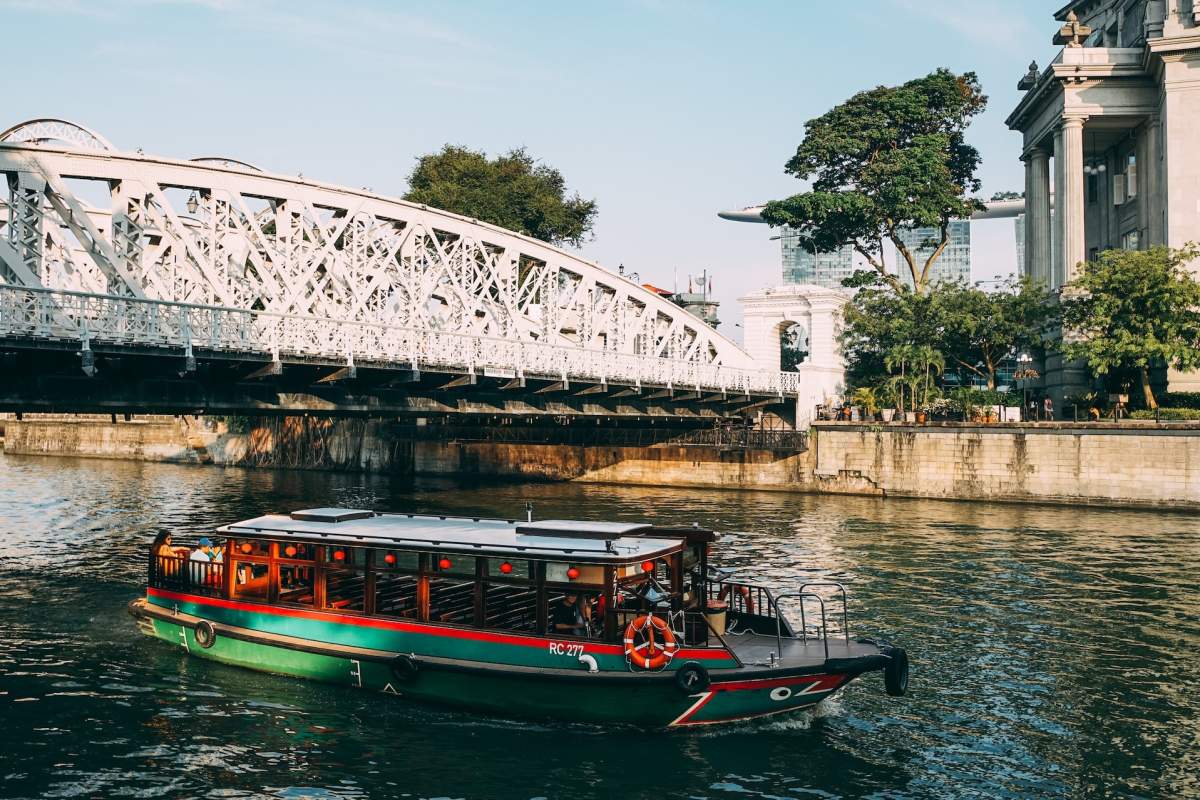 three brown wooden boat on blue lake water taken at daytime