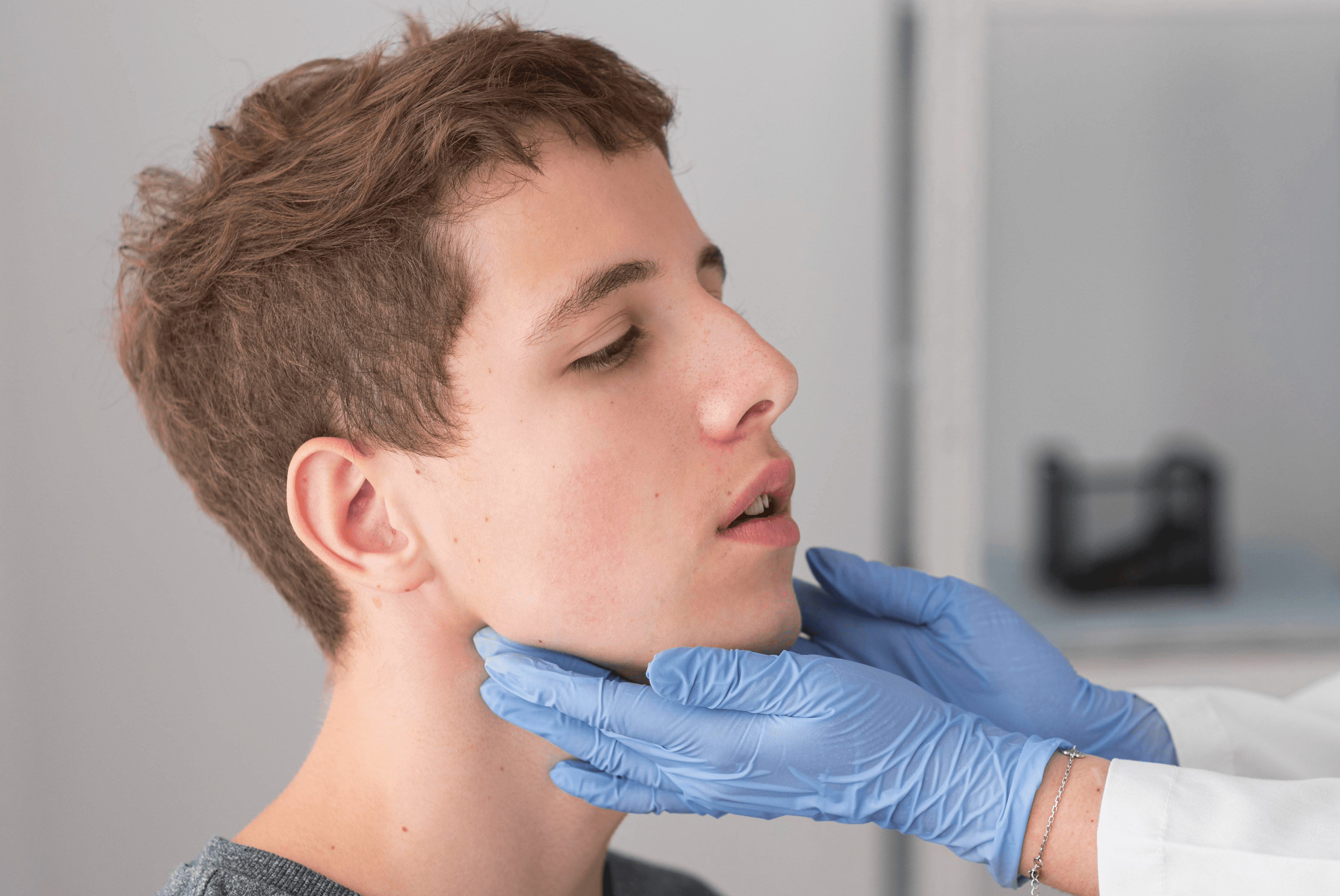 a woman laying on top of a bed holding a mans hand