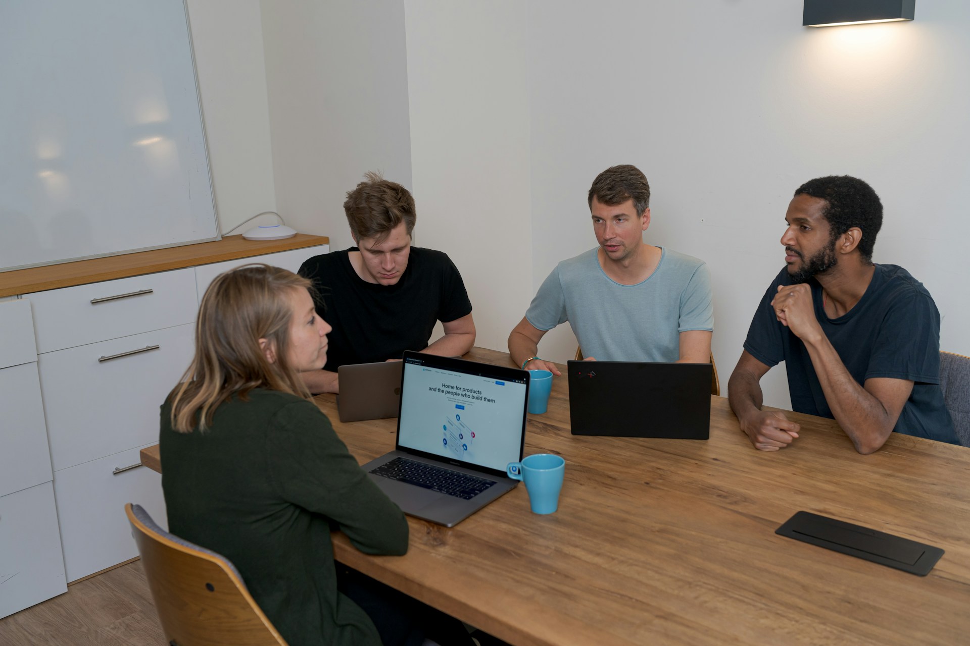 A group of people sitting around a table while discussing