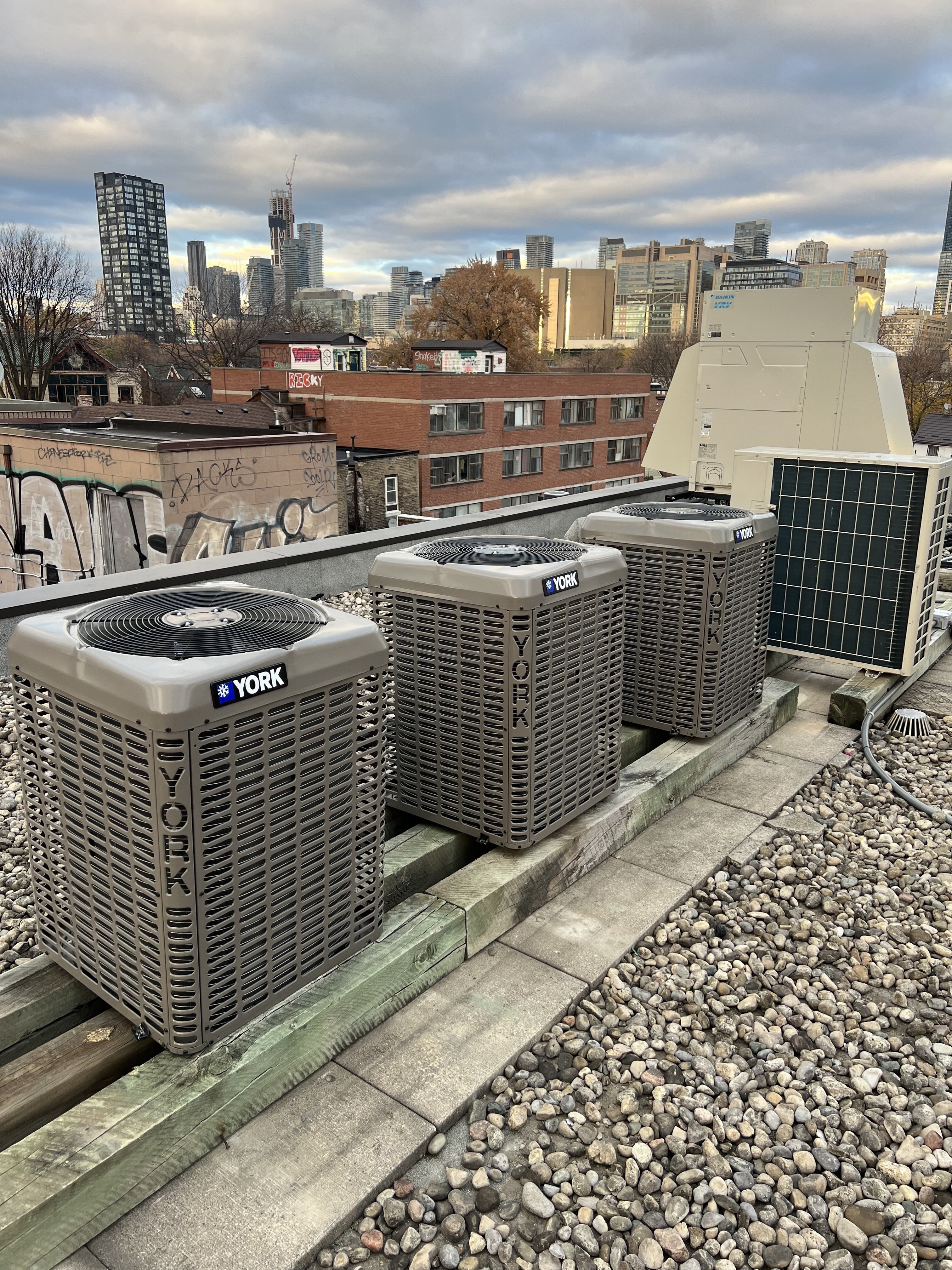 Commercial rooftop HVAC units installed on a Toronto building