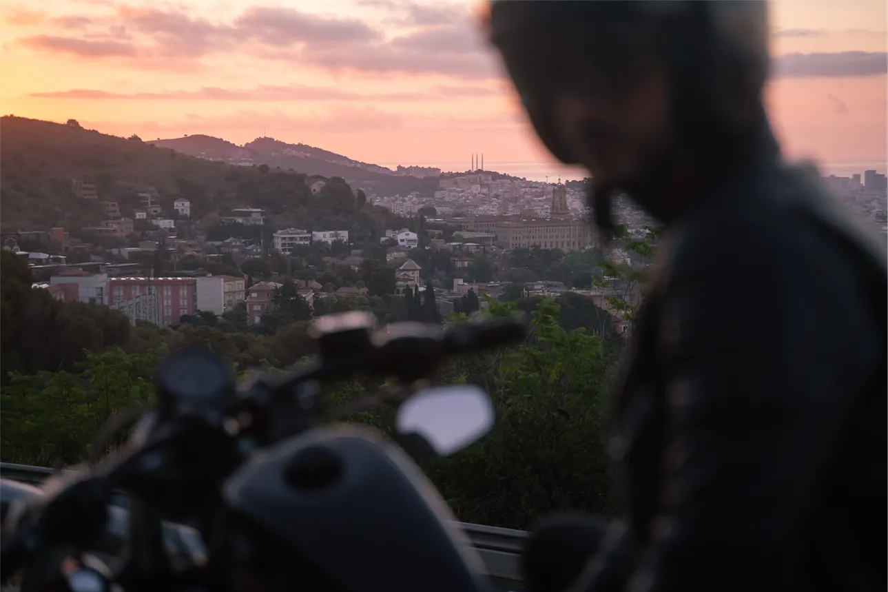 A motorcyclist riding through a bend on a wooded road