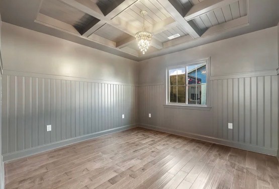 Modern glass and wood cabin with a cozy outdoor deck featuring wicker furniture, surrounded by lush green trees and a serene forest setting.