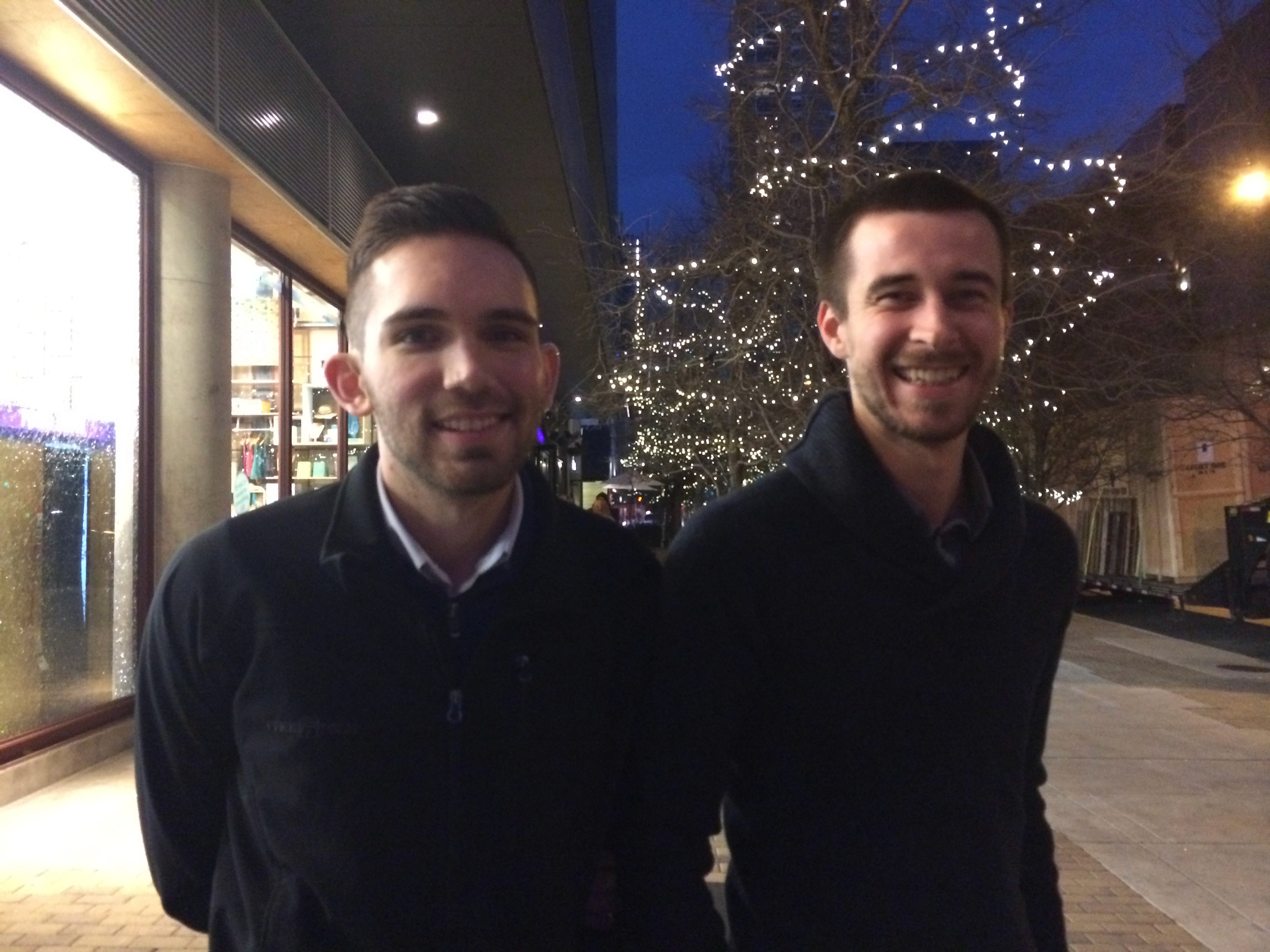 portrait of two men outside, on the sidewalk