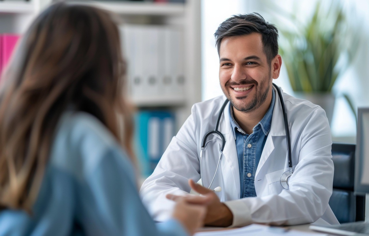 Smiling doctor talking to patient