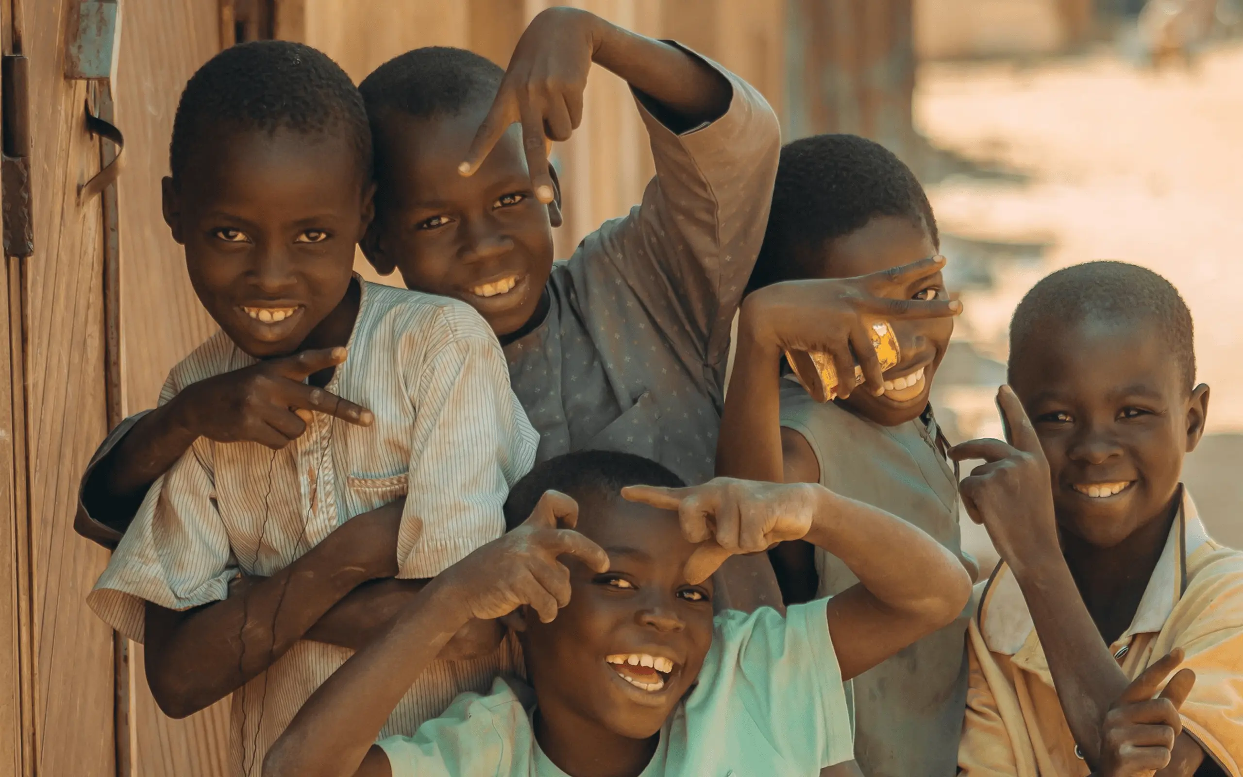 Group of smiling children looking at the camera.