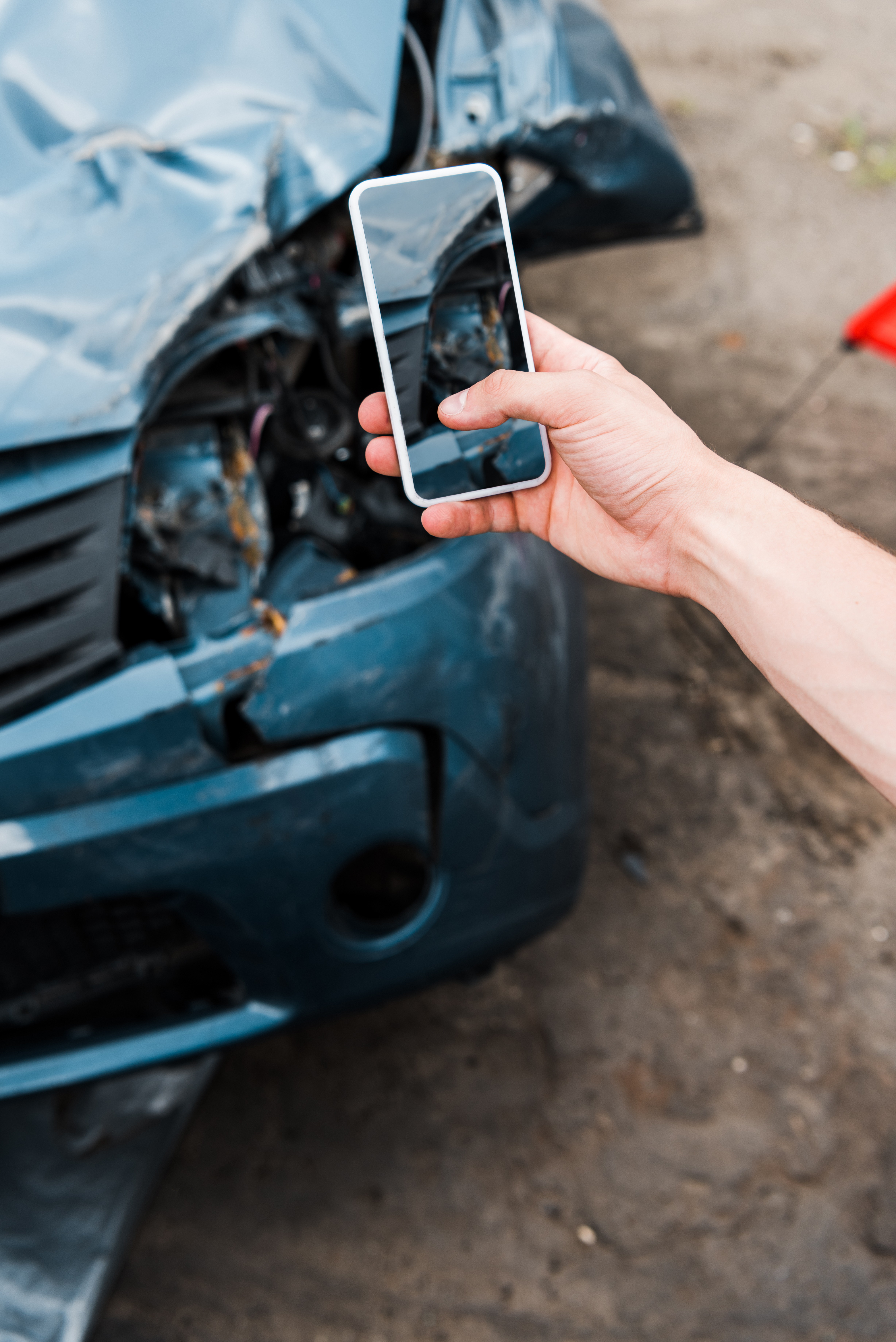 taking picture of damage at scene of car accident