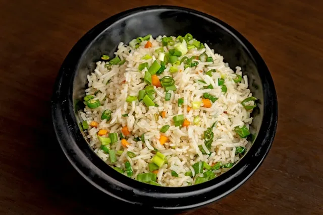 Healthy bowl of rice, vegetables, and tofu representing Buddhist balance