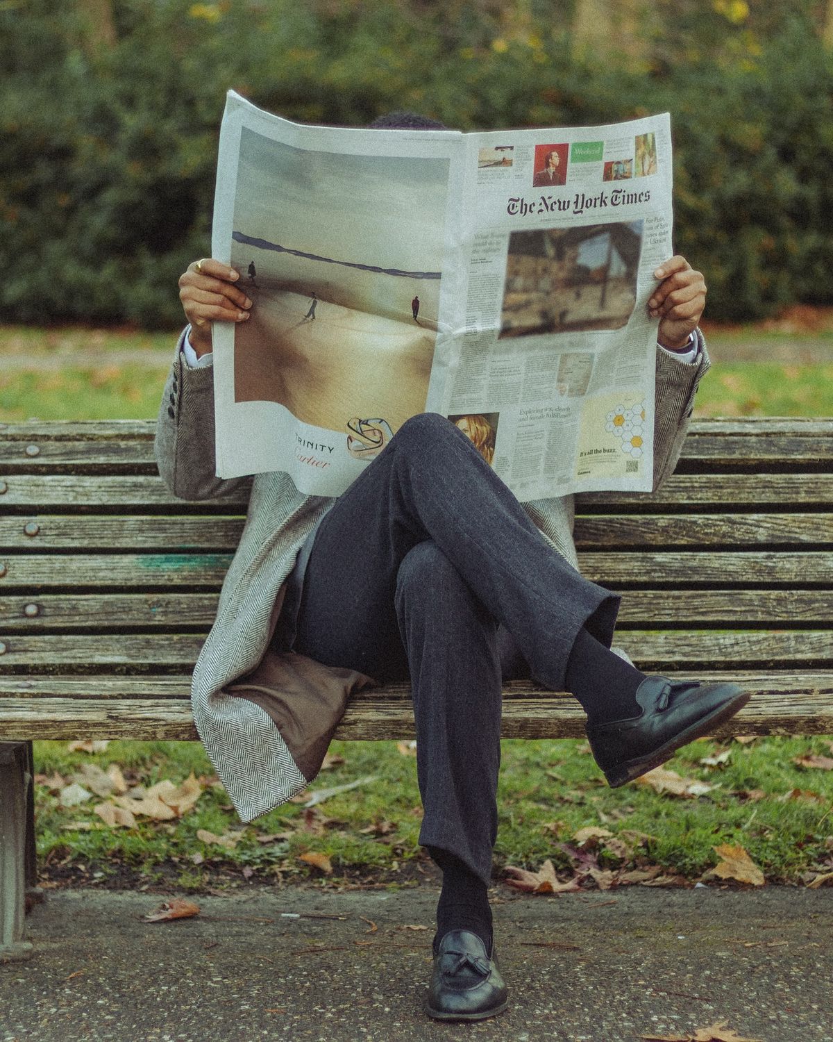 Portrait of a young man with short hair, wearing a dark t-shirt, against a plain background.