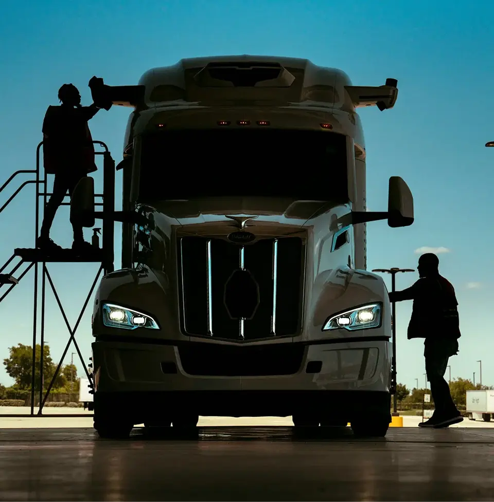 Engineers working on an autonomous truck at dusk