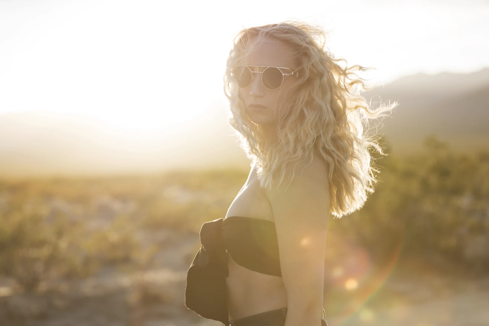 Portrait of an emerging artist bathed in golden sunlight, captured in the Utah desert.