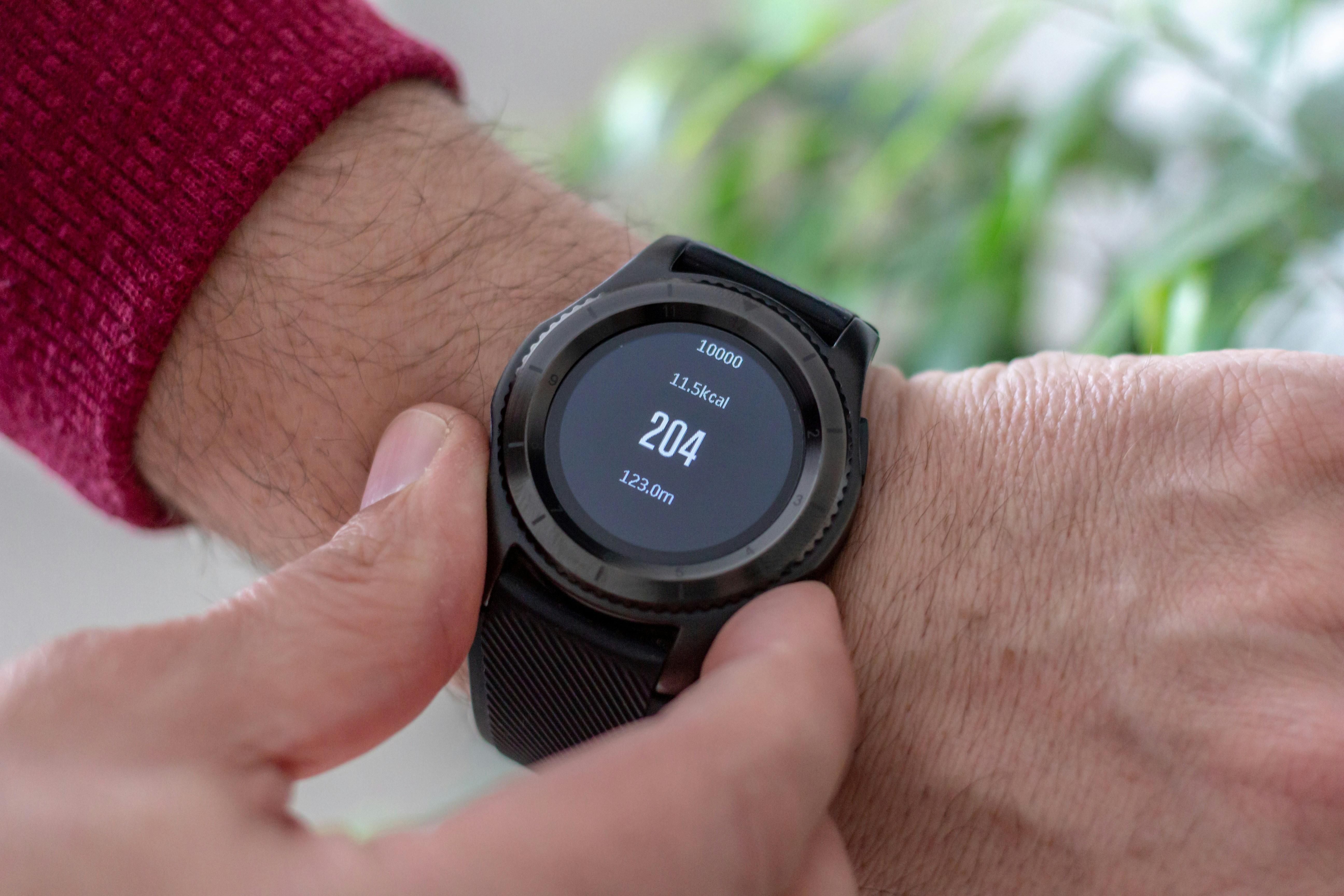 Picture of a man holding a smartwatch