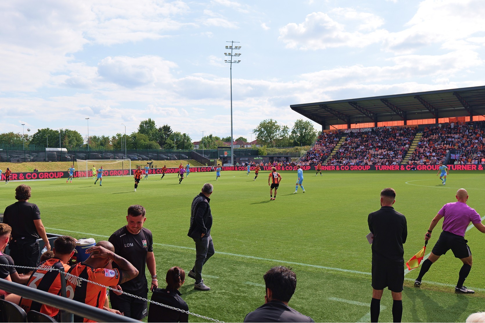 Football match at the Barnet FC with players on the field ready to score