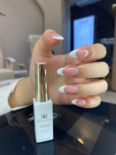 a woman getting her nails done at a nail salon