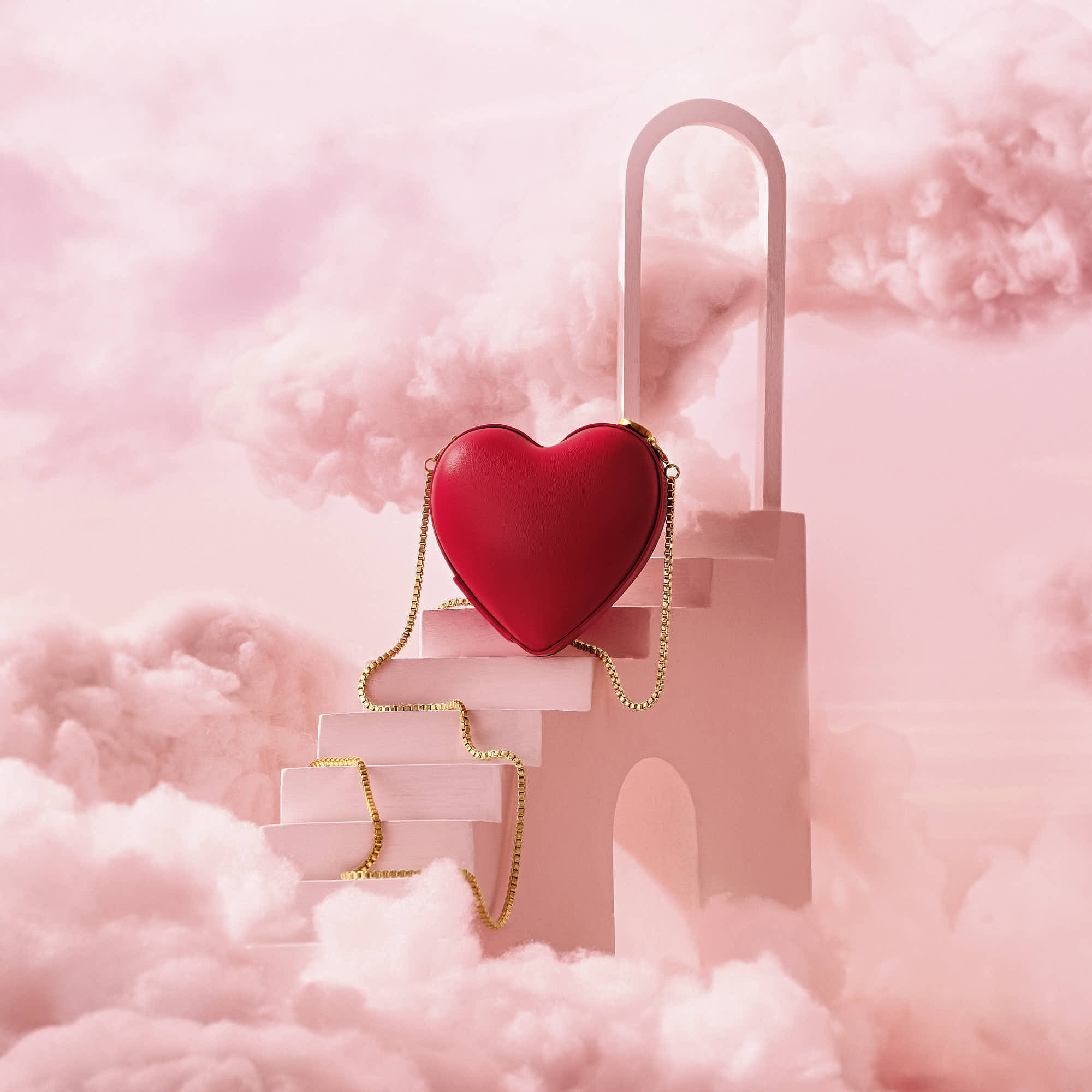 Red heart-shaped purse on dreamy pink cloud staircase background.