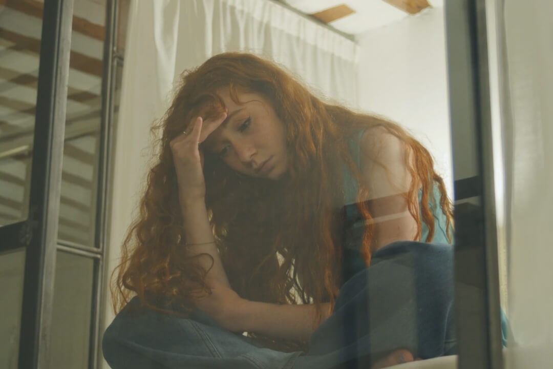 teenager in her bedroom feeling isolated from friends