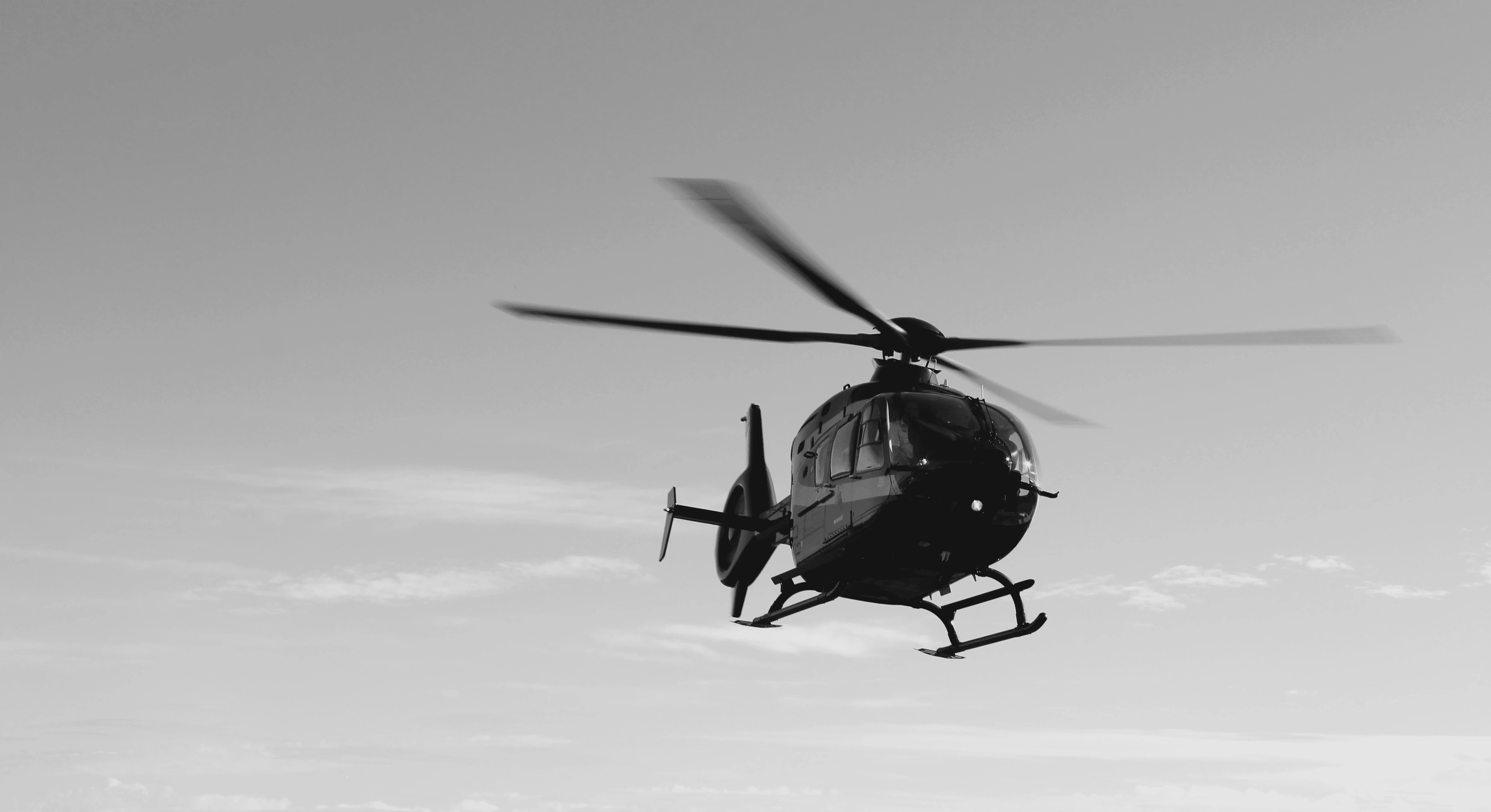 A helicopter flying over clear skies