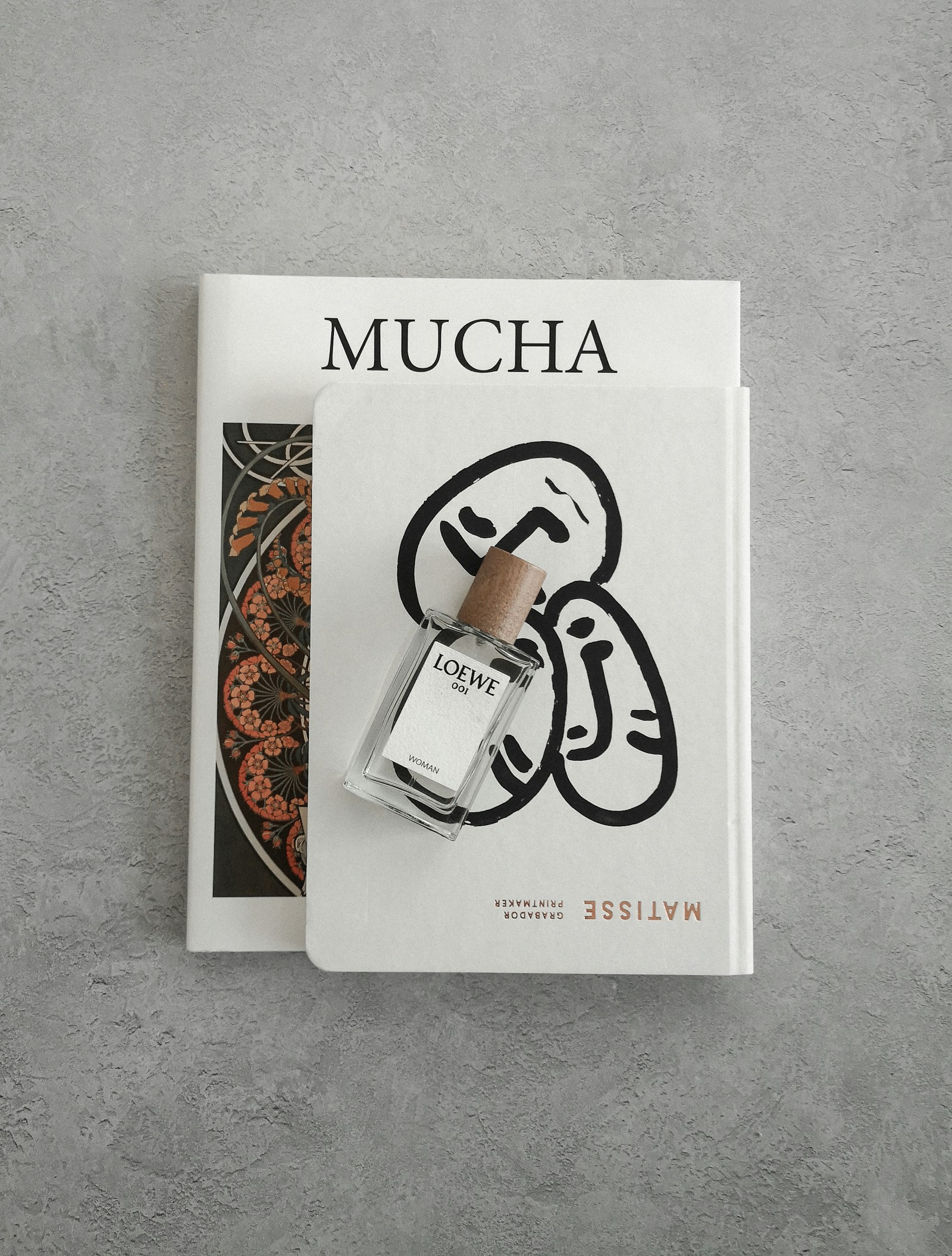 Hojarasca Ediciones — a bottle of perfume sitting on top of a book