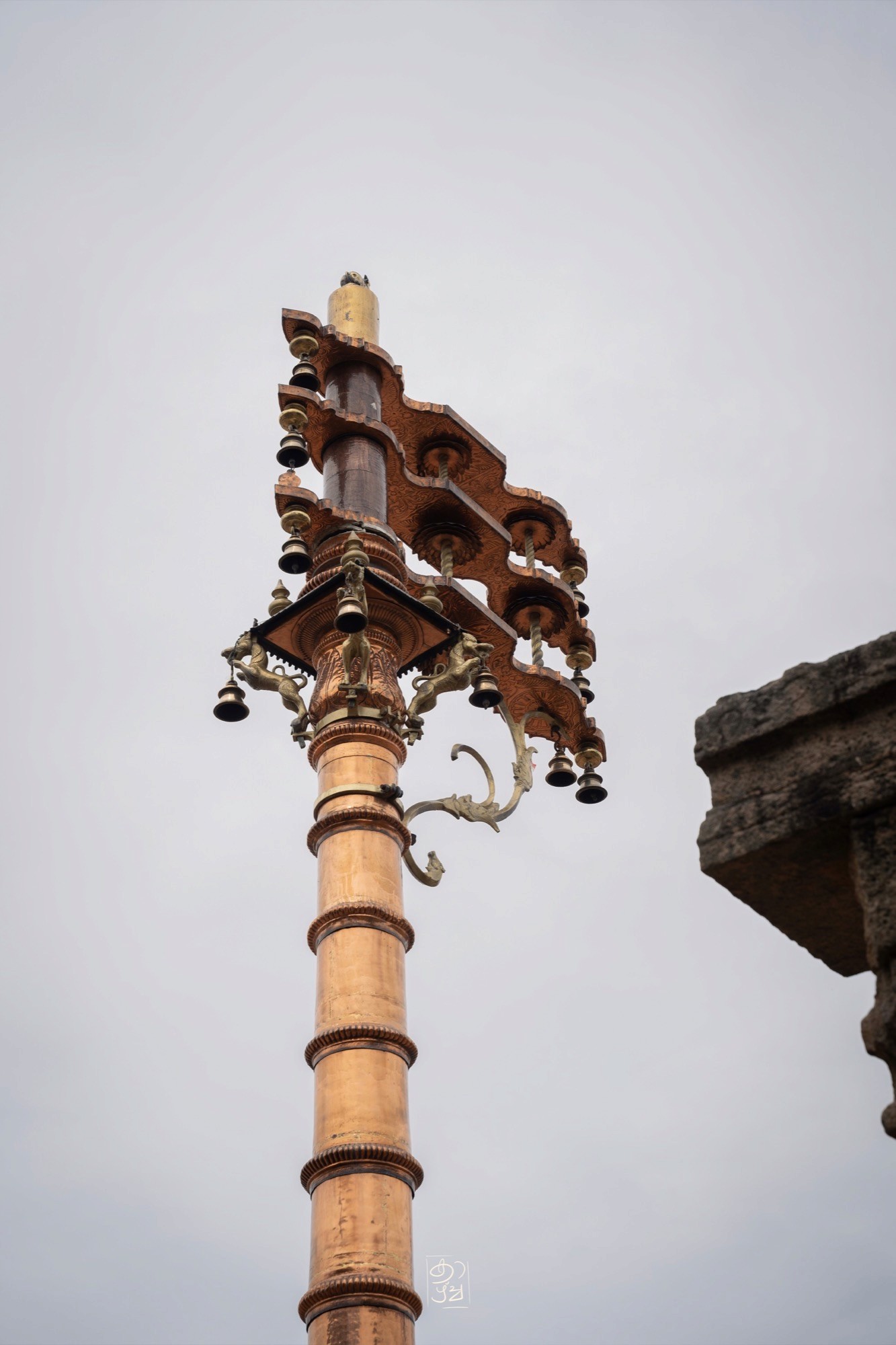 The brass-clad flagstaff in the temple courtyard