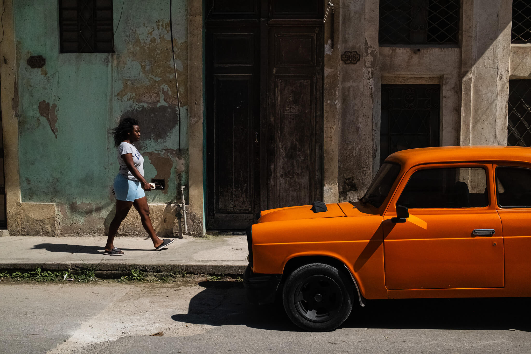 WOMAN WALKING IN OLD HAVANA