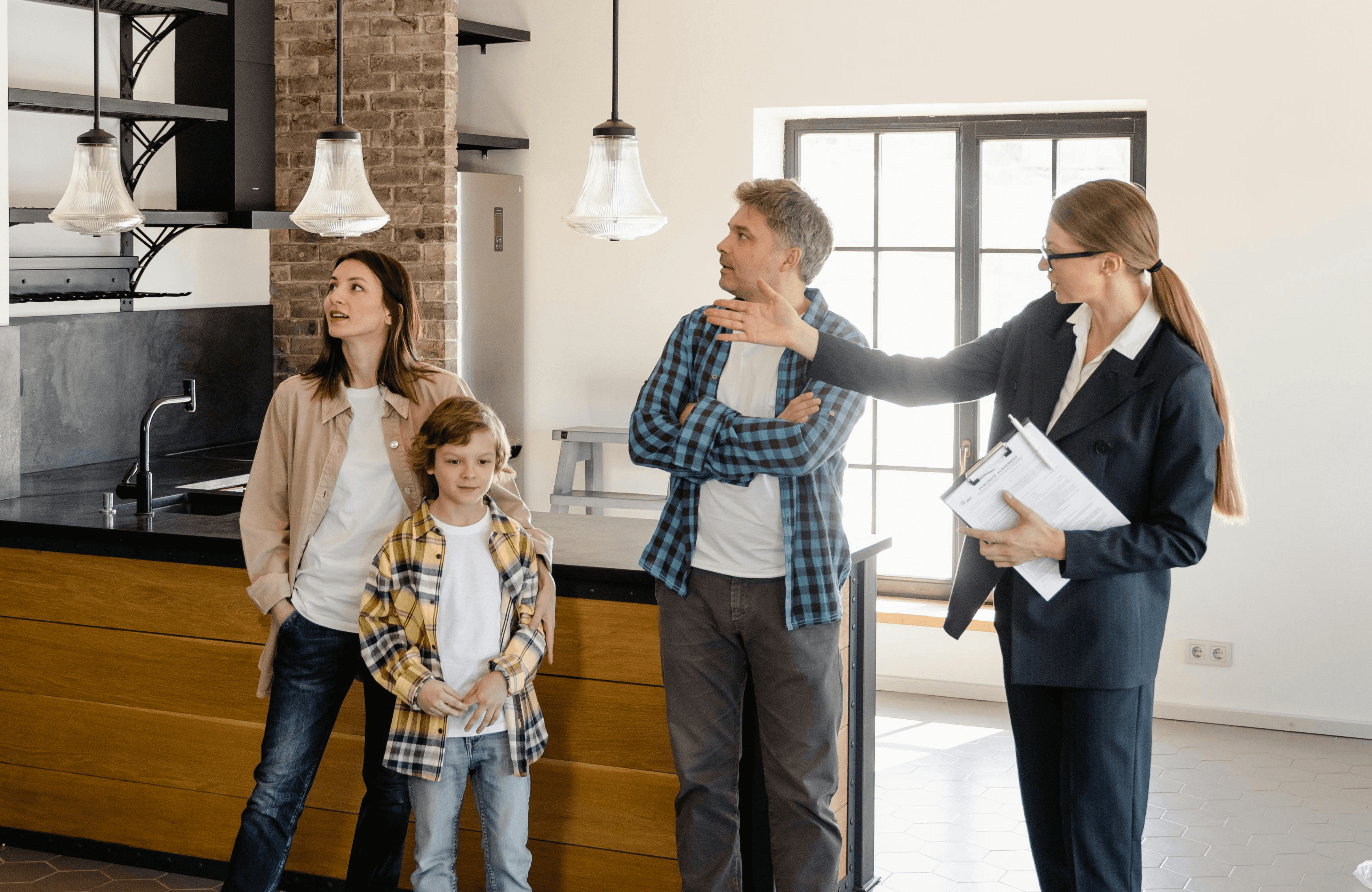 a family with a property agent showing them around a house