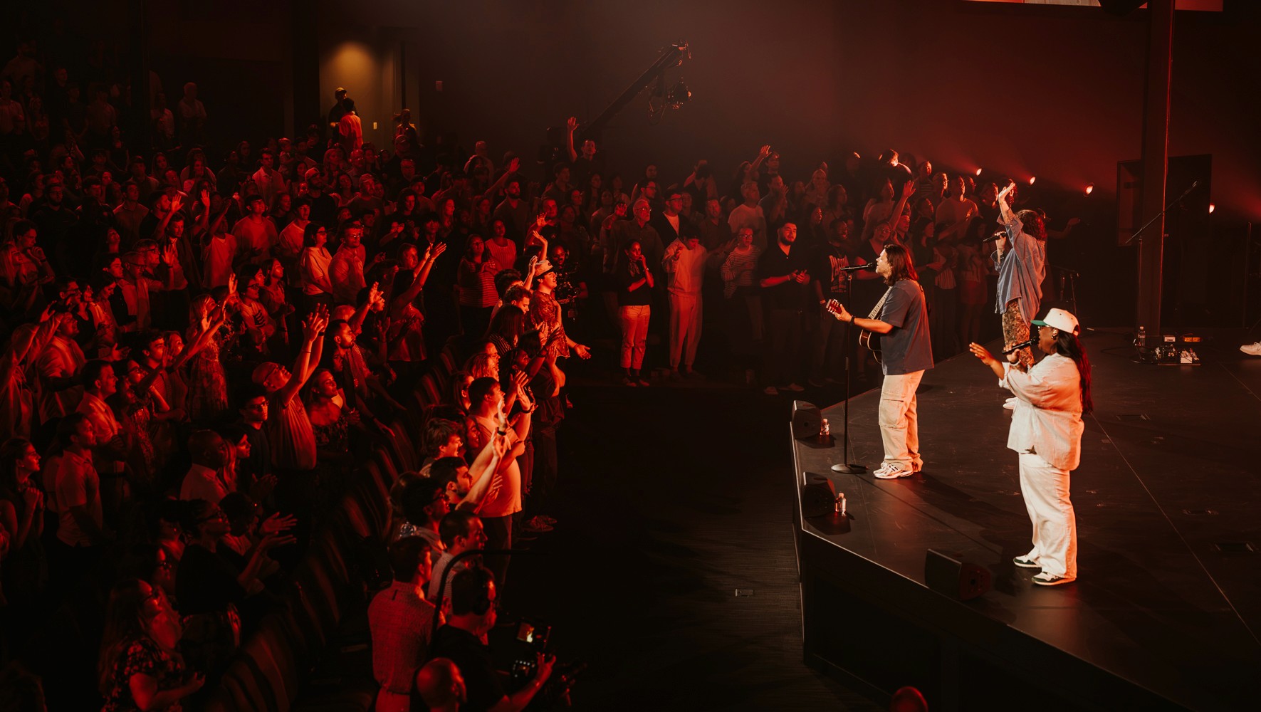 Wide worship auditorium in red stage light
