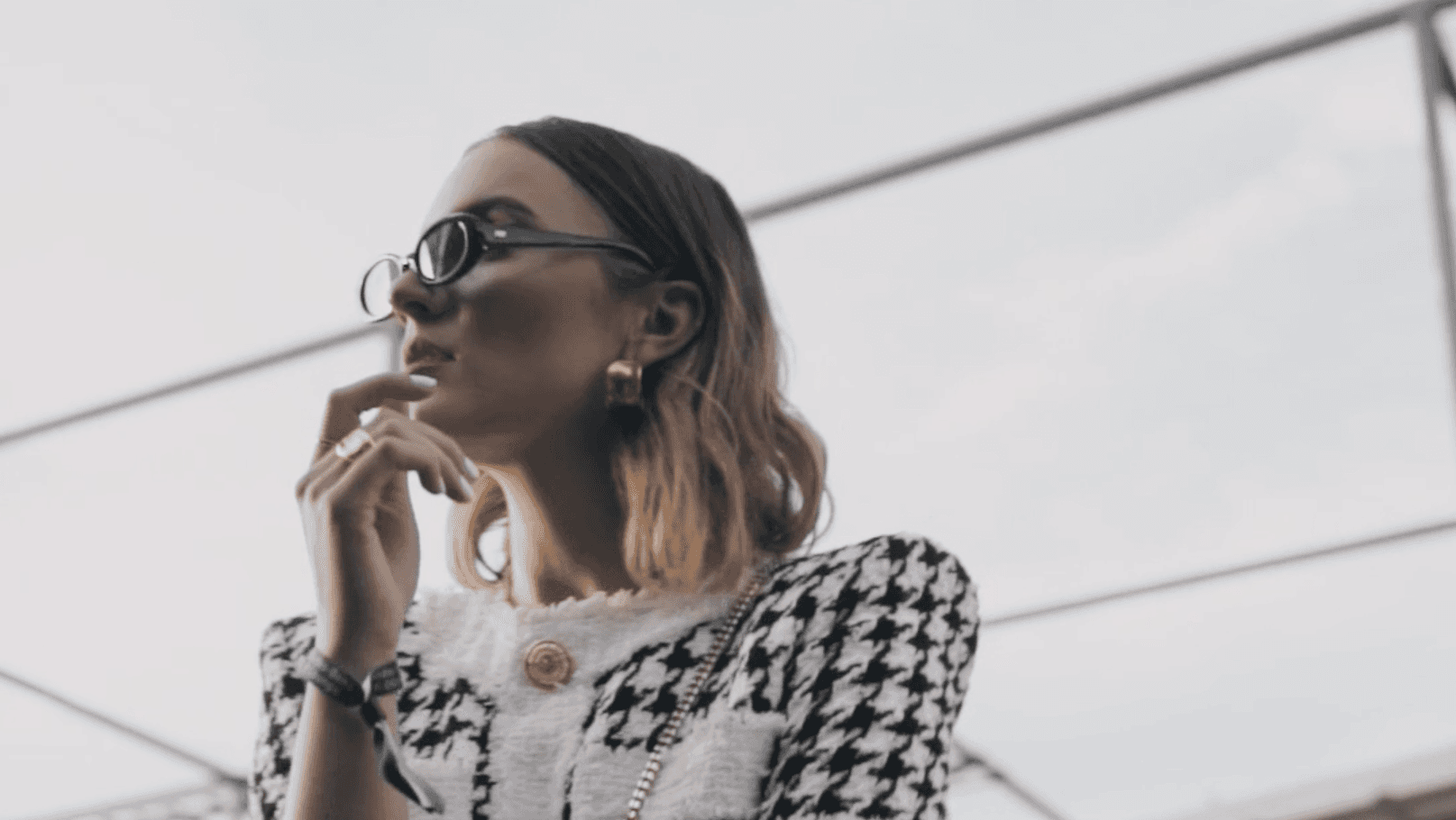 Close-up of a person wearing glasses, speaking or singing into a microphone