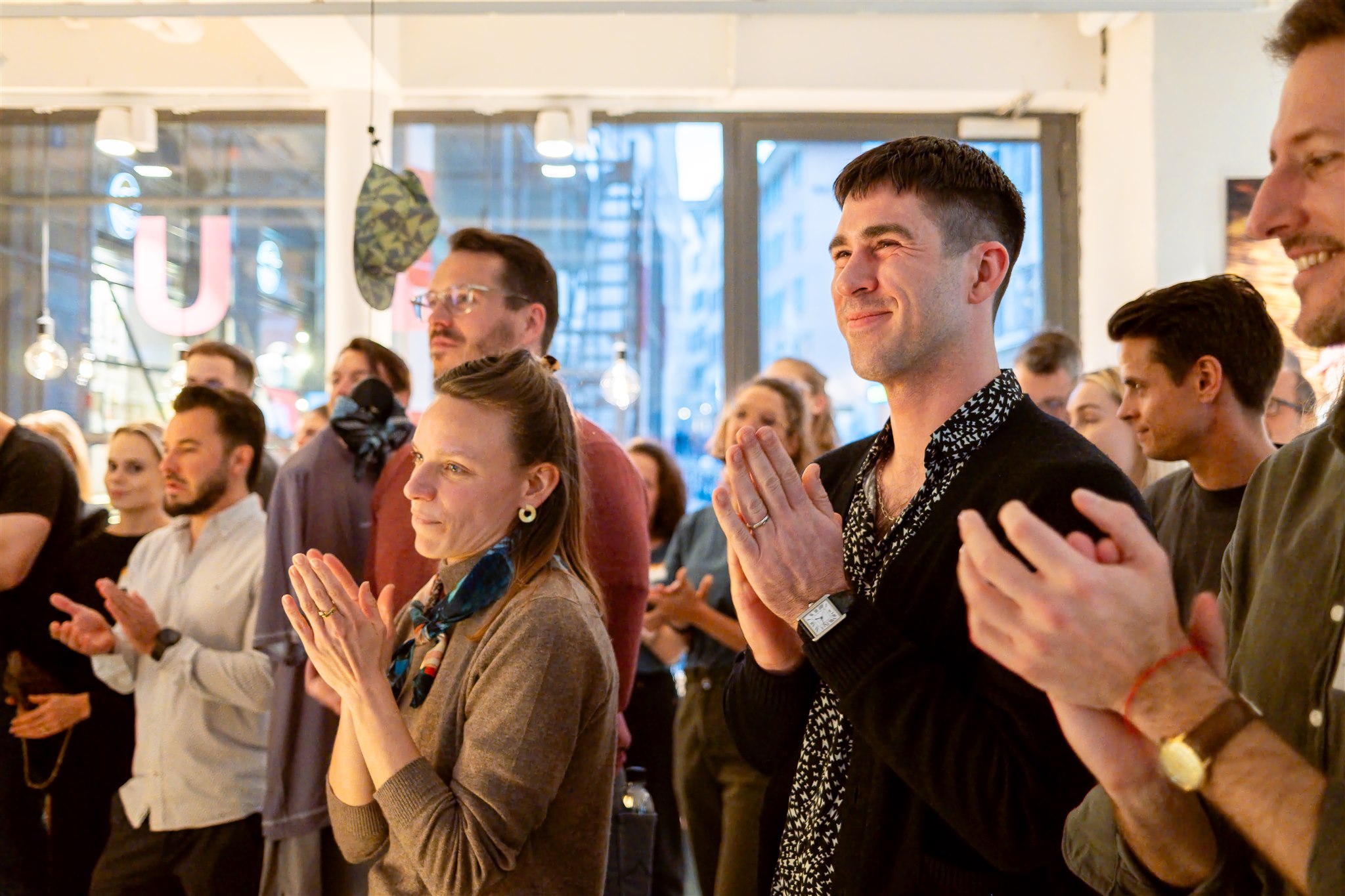 Event photography Zurich audience applauding at augo product launch