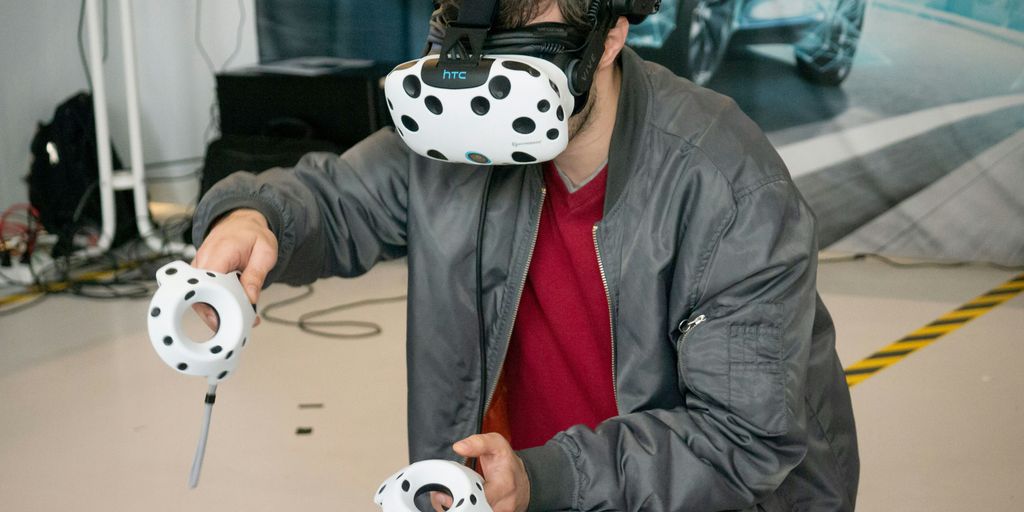 man in black jacket and blue denim jeans with white and black panda mask