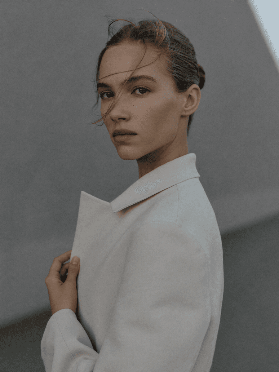 woman raising both arms with stripe light color