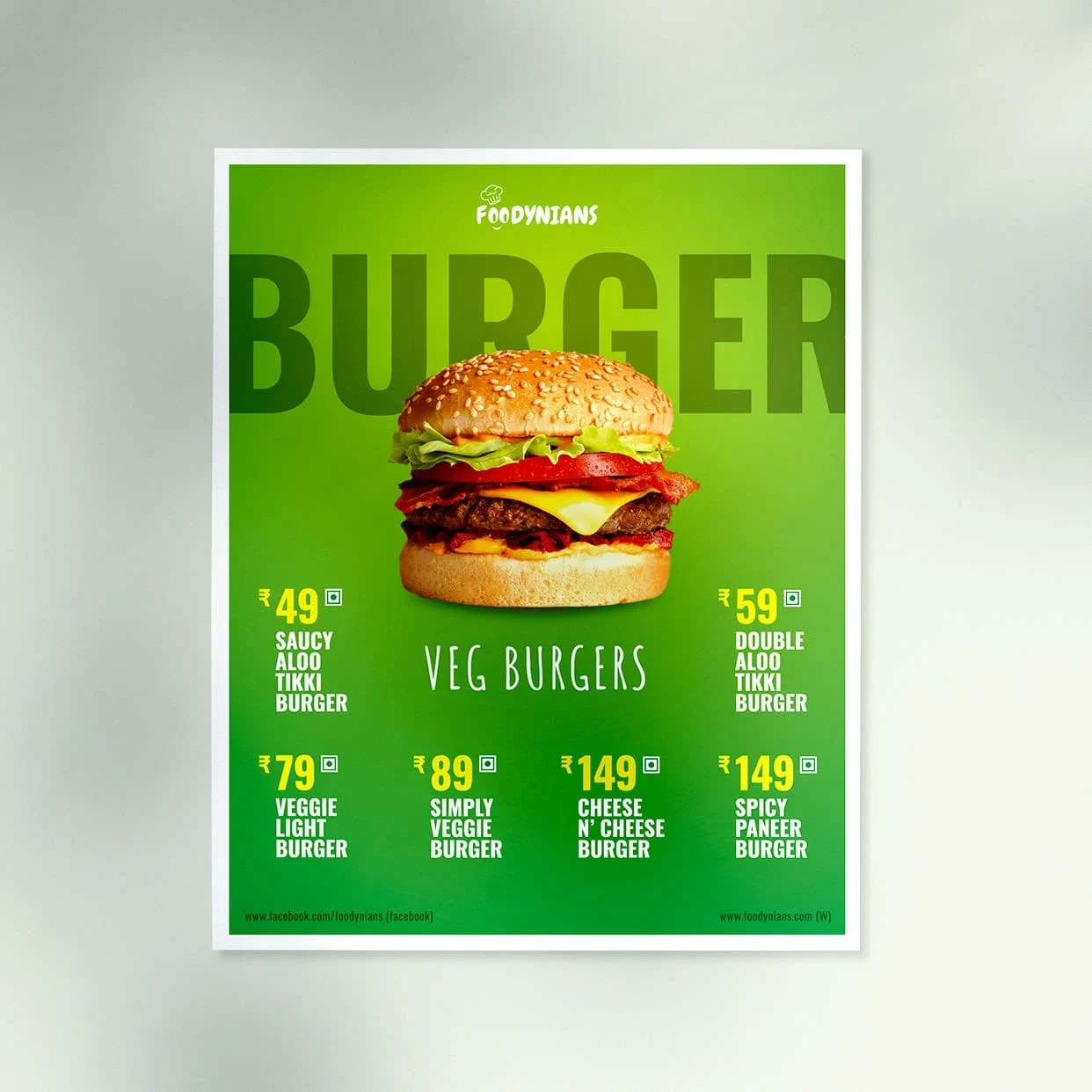 Green Foodynians poster featuring a large veggie burger on a bright green background, with six vegetarian burger options and prices from ₹49 to ₹149.