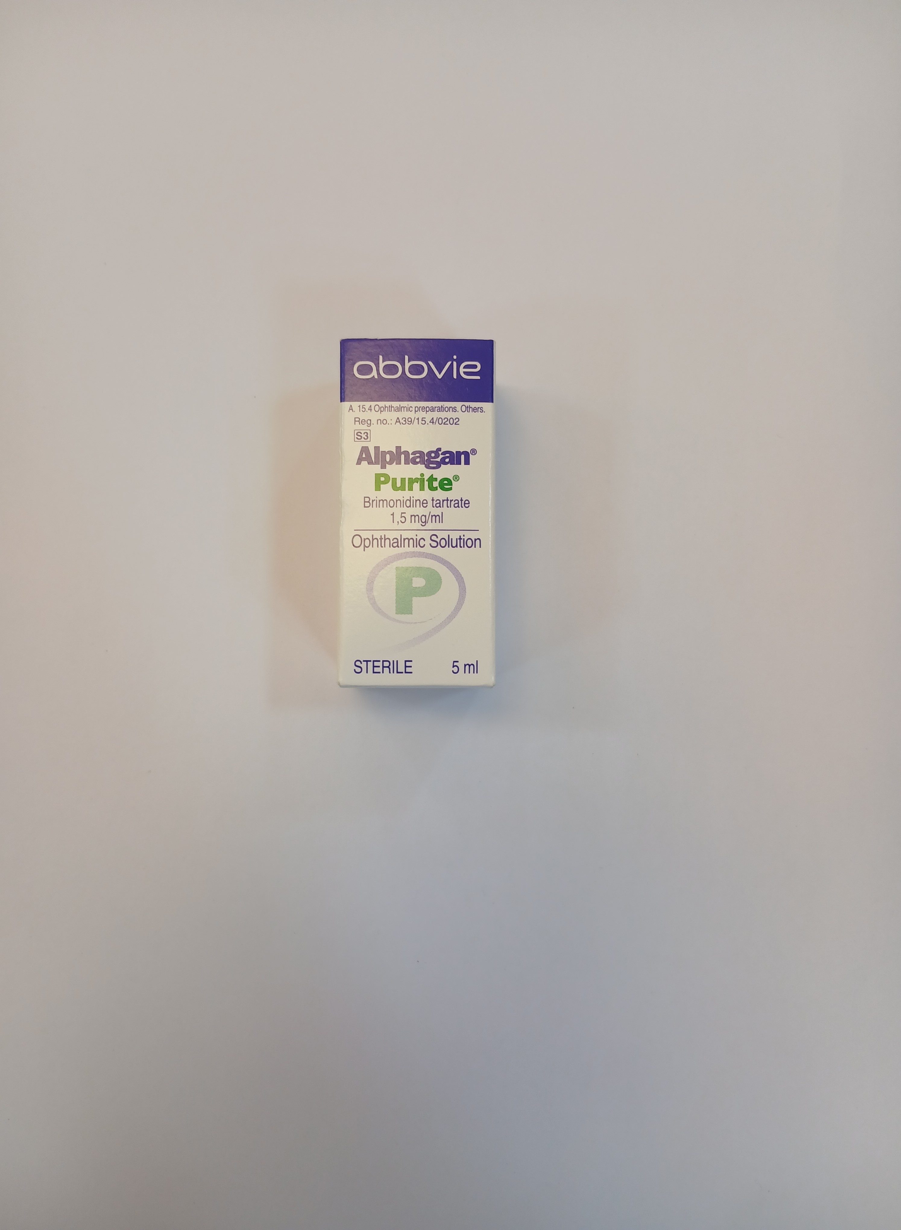 White cardboard packaging with a clear plastic window displays a small, sterile, single-dose vial containing a liquid solution.