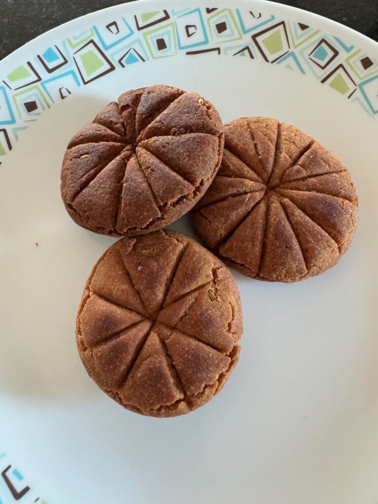 Thekuas, the deep-fried Indian sweet, arranged on a plate.