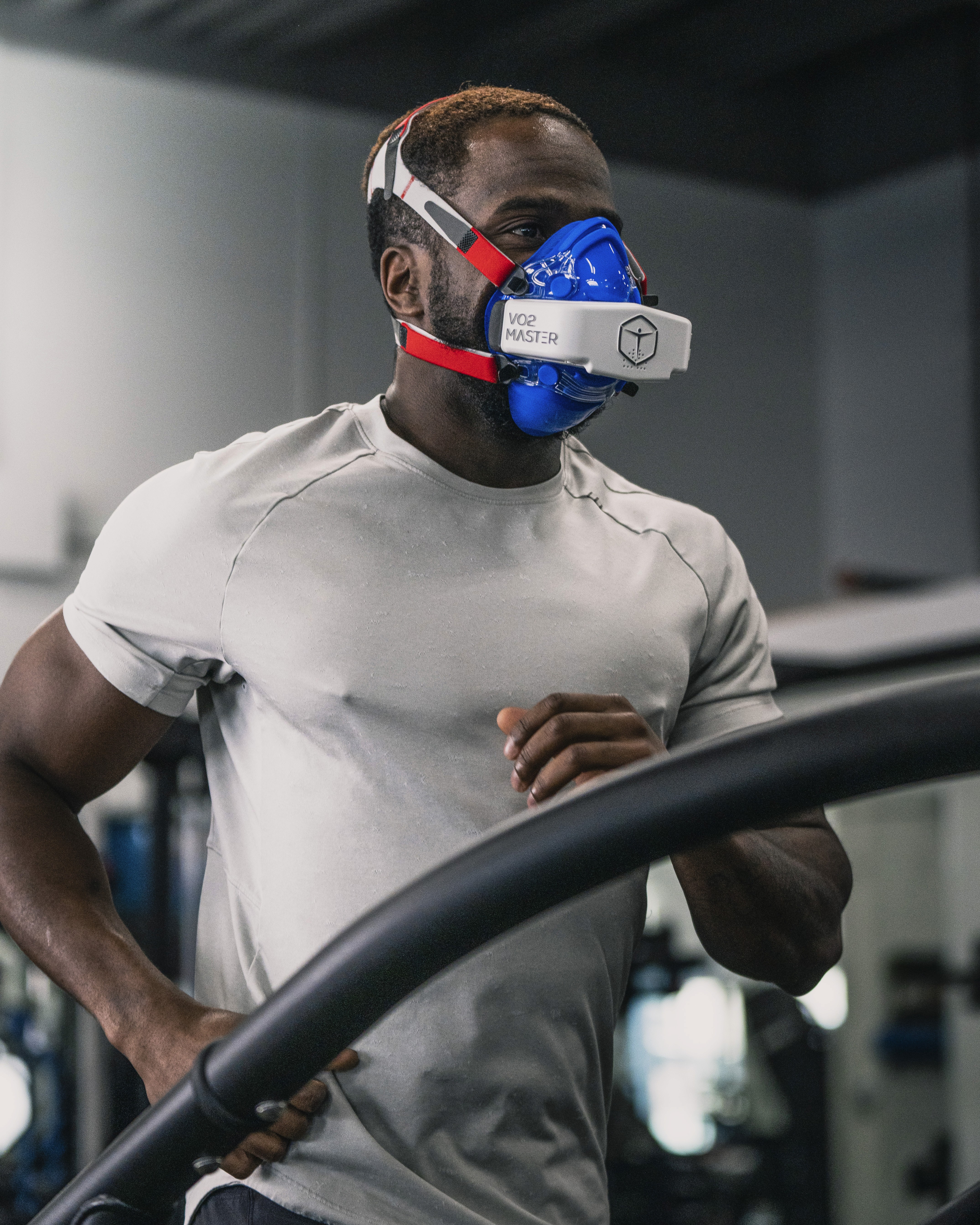 Male athlete performing cobra stretch on a gym floor, promoting spinal mobility, core activation, and recovery as part of injury prevention and rehab training.