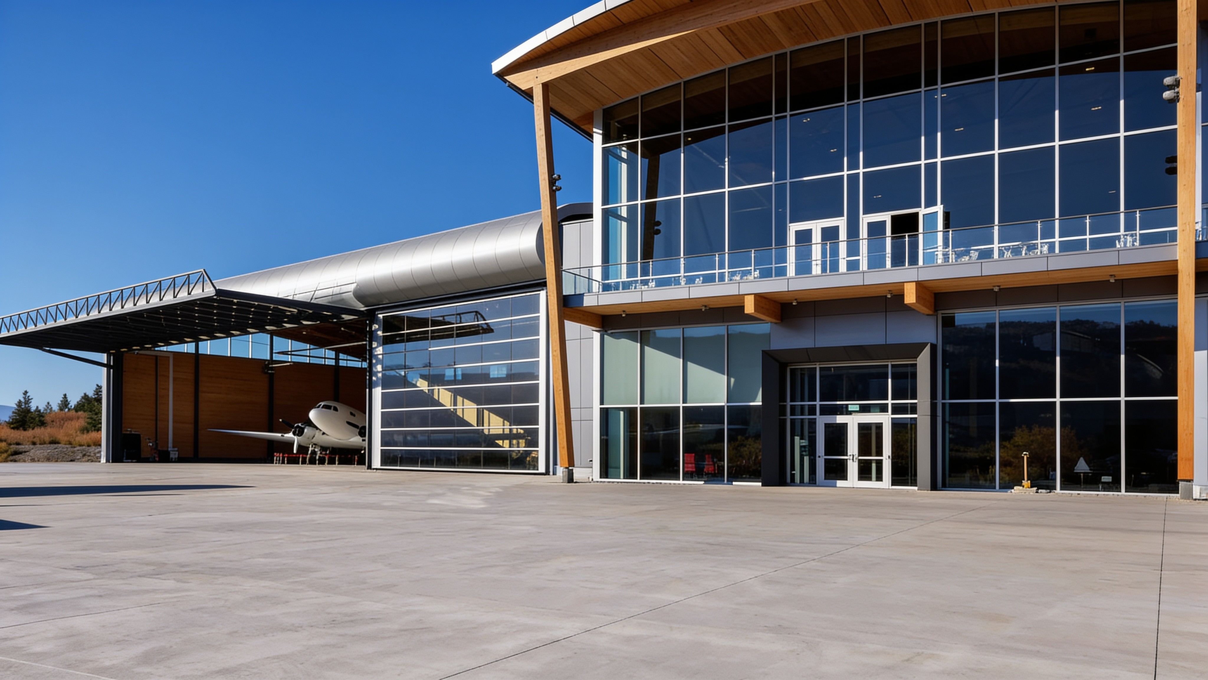 Aerospace centre hangar with a raised hydraulic door and jet