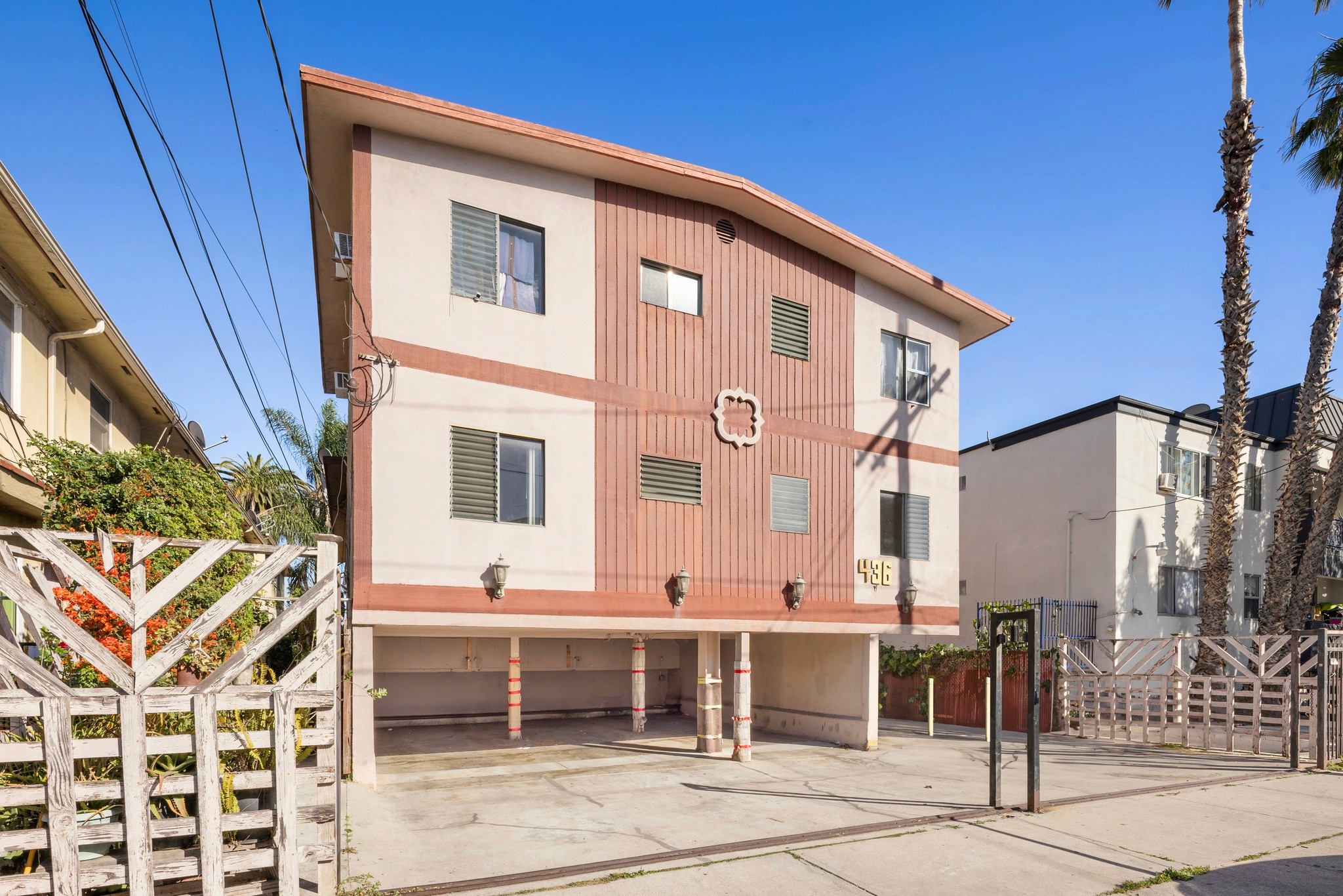 Front exterior of multifamily building with covered parking at 436 Normandie Pl.